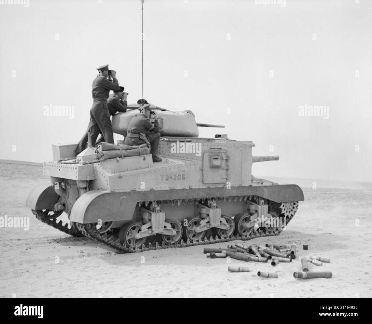 The British Army in North Africa 1942 The Commander in Chief, General Sir Claude Auchinleck, (farthest from the camera) and Major General Campbell, VC, standing on a Grant tank, watching as it fires at a practise target in the Western Desert, 17 February 1942. Stock Photo