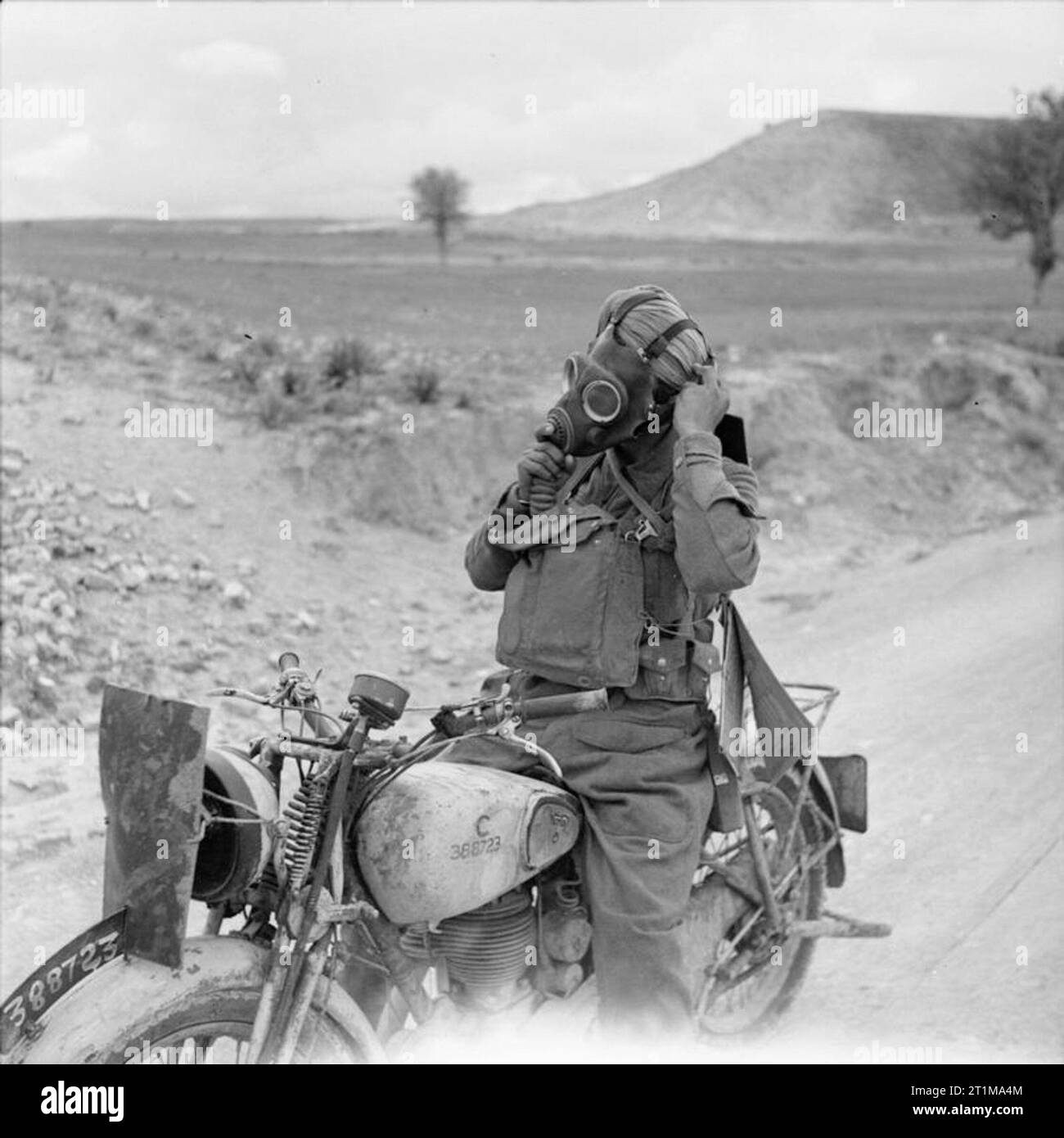 British Forces in Cyprus 1942 A motorcycle despatch rider putting on ...