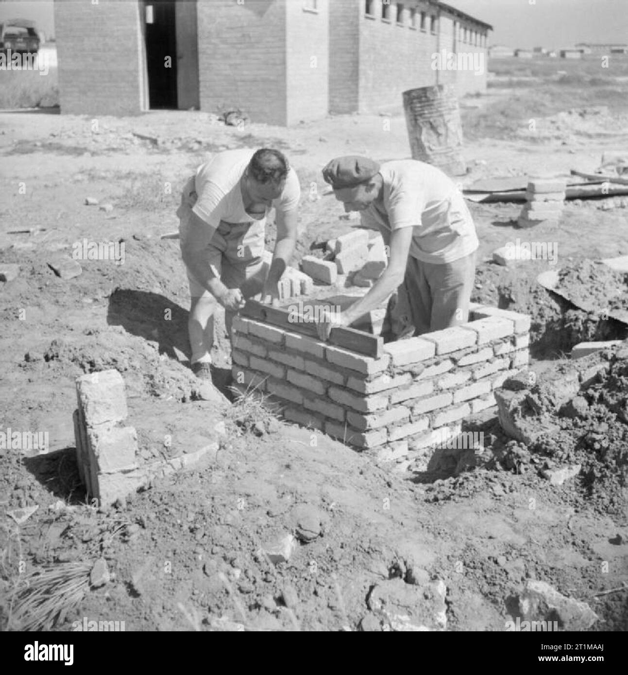 British Forces in the Middle East, 1945-1947 Company Sergeant Major G Melville (left) and Gunner G Maher practice bricklaying as part of the process of retraining for civilian careers after demobilisation. Stock Photo