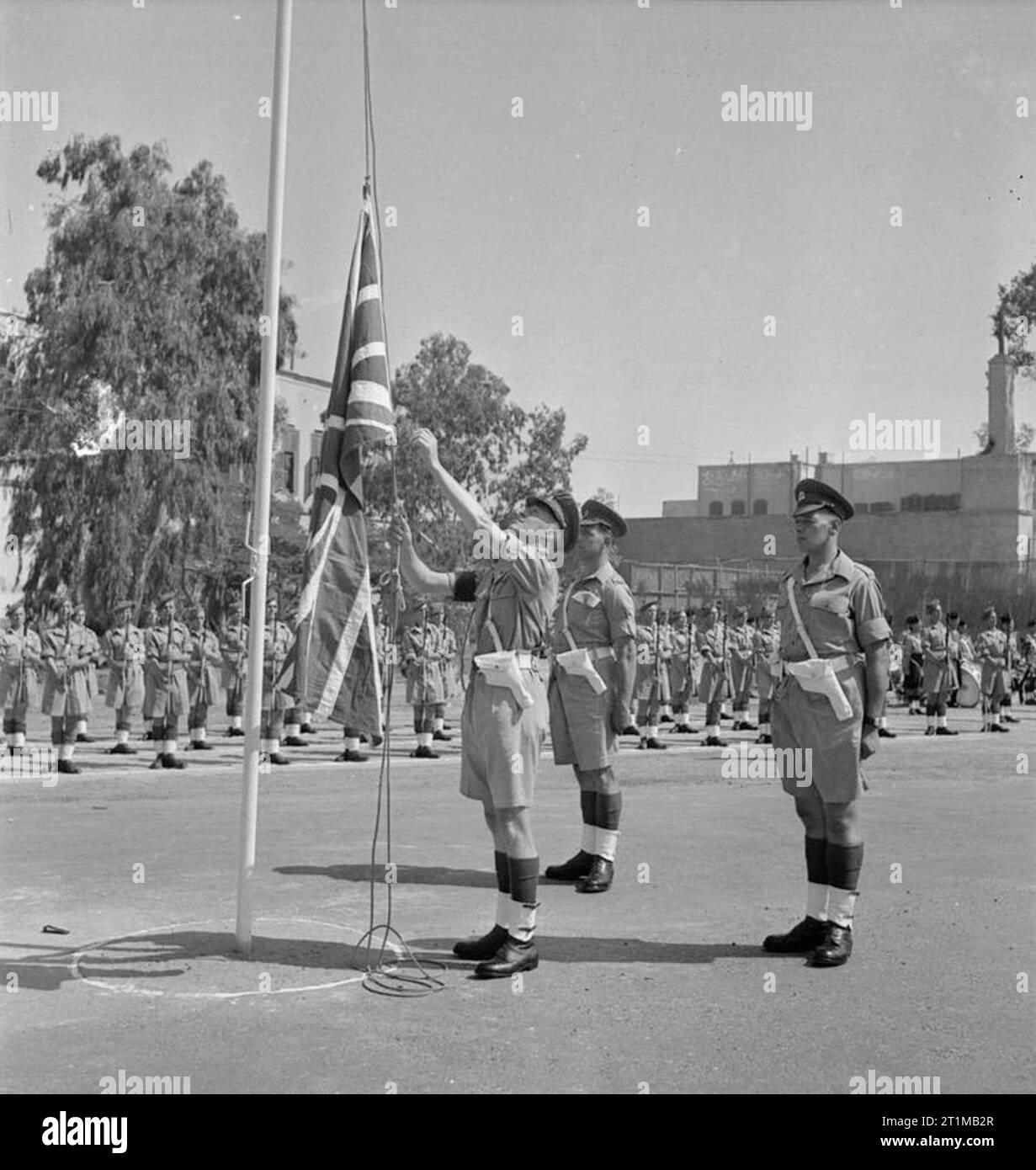 British Forces in the Middle East, 1945-1947 A sergeant of the Corps of Military Police lowers the Union Jack during the ceremony to mark the formal handover of the Citadel in Cairo to local control. This ceremony was the first step towards the ending of British rule in Egypt. Stock Photo