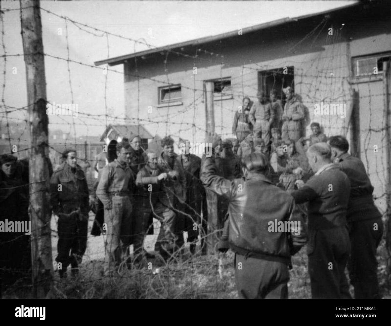 The British Army in North-west Europe 1944-45 A photograph taken covertly at Stalag VIIA at Mooseburg, showing British POWs talking to new inmates captured on the Greek island of Leros. Date unknown. Stock Photo