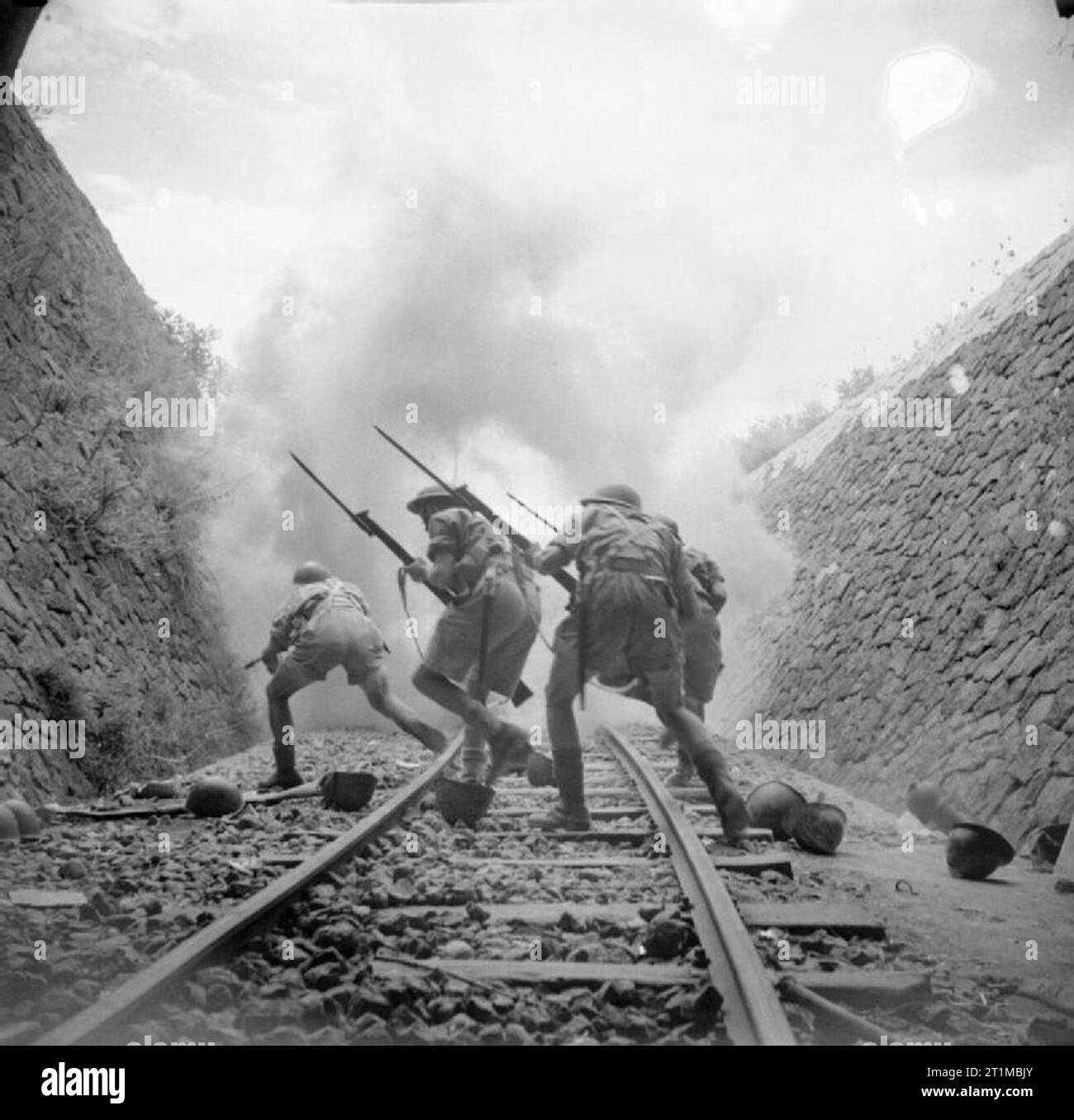 The British Army in Sicily 1943 Posed photograph of infantry attacking along a railway cutting, 25 July 1943. Stock Photo