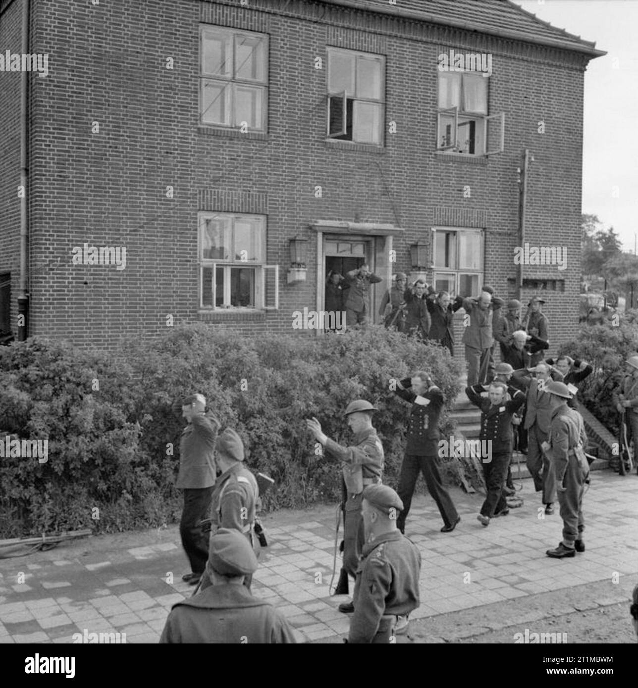 Germany Under Allied Occupation Prisoners being led away from the house in Mürwik a few miles from Flensburg, where members of the German Government were located. The operation was carried out by men of 'A' Company, 1st Battalion, The Cheshire Regiment. In total, twelve 'Grade 1' prisoners were taken including General Jodl. Stock Photo
