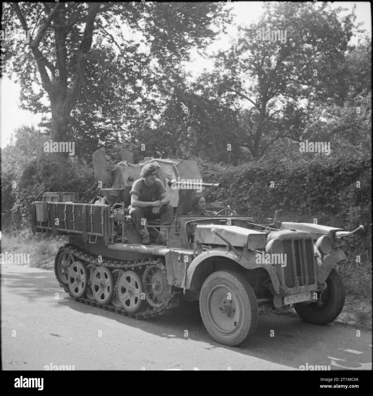The British Army in the Normandy Campaign 1944 6th Airborne soldiers aboard a captured German half-track mounting a 20mm gun, which they used to shoot down a German aircraft, 28 August 1944. Stock Photo