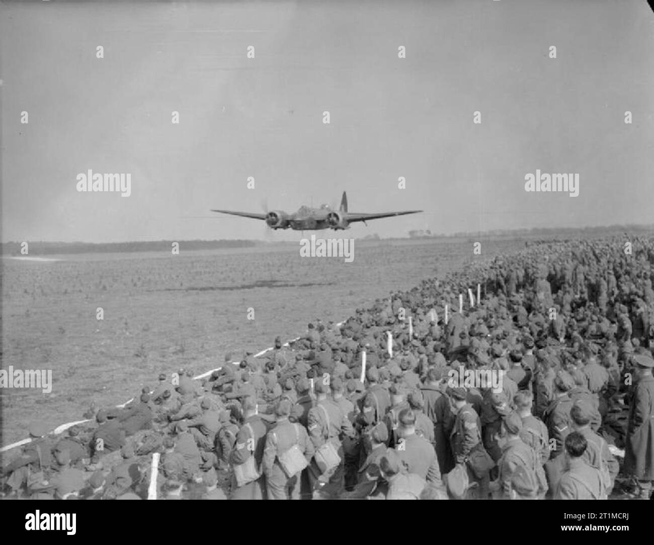 The British Army in the United Kingdom 1939-45 An RAF Blenheim IV light bomber flies low to lay a smokescreen during a demonstration of air power in front of a gathering of Regular and Home Guard officers and NCOs in East Anglia, 29 March 1942. During the display fighter aircraft strafed ground targets, bombers carried out low-level attacks and parachute and glider forces were also deployed. Stock Photo