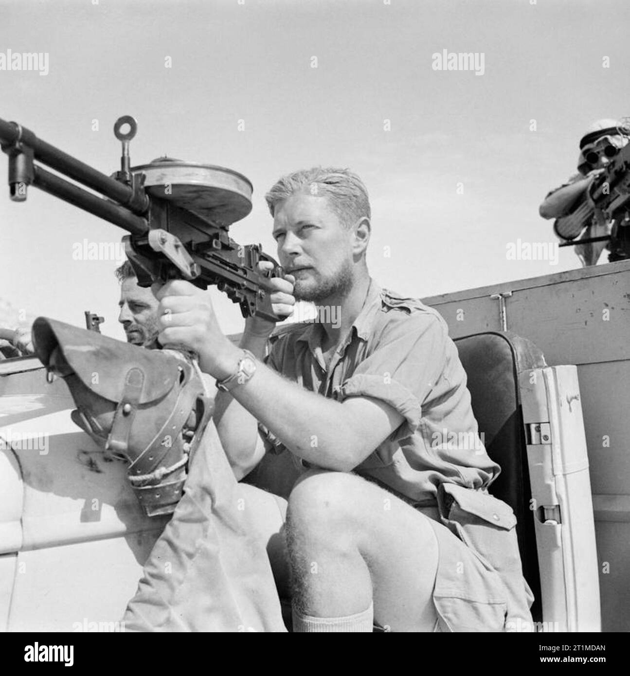 A member of a Long Range Desert Group (LRDG) patrol poses with a Vickers 'K' Gas-operated machine gun on a Chevrolet 30-cwt truck, May 1942. A member of a Long Range Desert Group (LRDG) patrol poses with a Vickers 'K' Gas-operated machine gun on a Chevrolet 30cwt truck, May 1942. Stock Photo