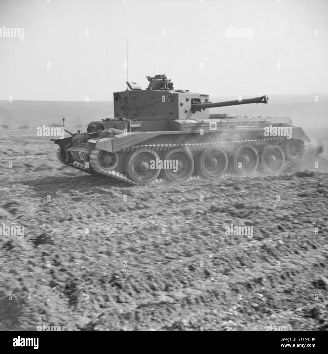 The British Army in the United Kingdom 1939-45 A Cromwell Mk IV of No. 2 Squadron, 2nd (Armoured Reconnaissance) Battalion, Welsh Guards, at Pickering in Yorkshire, 31 March 1944, displays its speed during an inspection by Winston Churchill. The tank is named 'Blenheim'. This tank was the mount of Major John Ogilvie Spencer, commanding No. 2 Squadron, and later killed in Belgium on 9 September 1944. Stock Photo