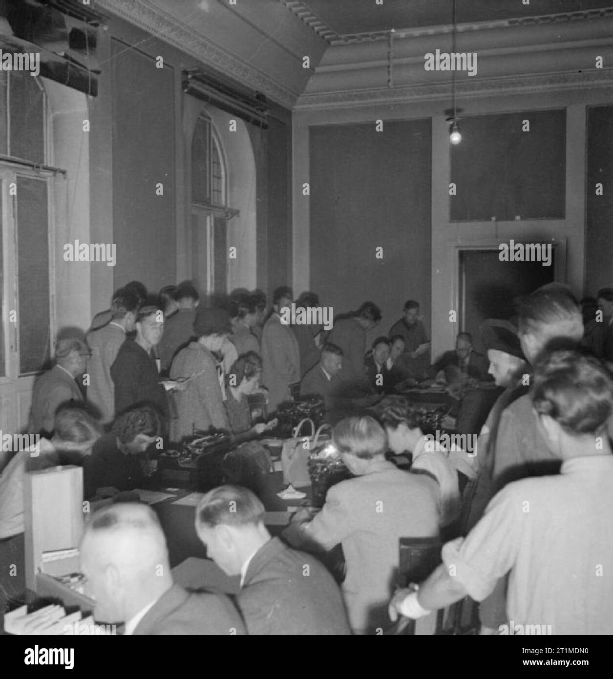 Germany Under Allied Occupation Crowds of German civilians in Hanover Rathaus (townhall) waiting for permission to obtain passes from the Public Safety Department of the Allied Military Government. Stock Photo