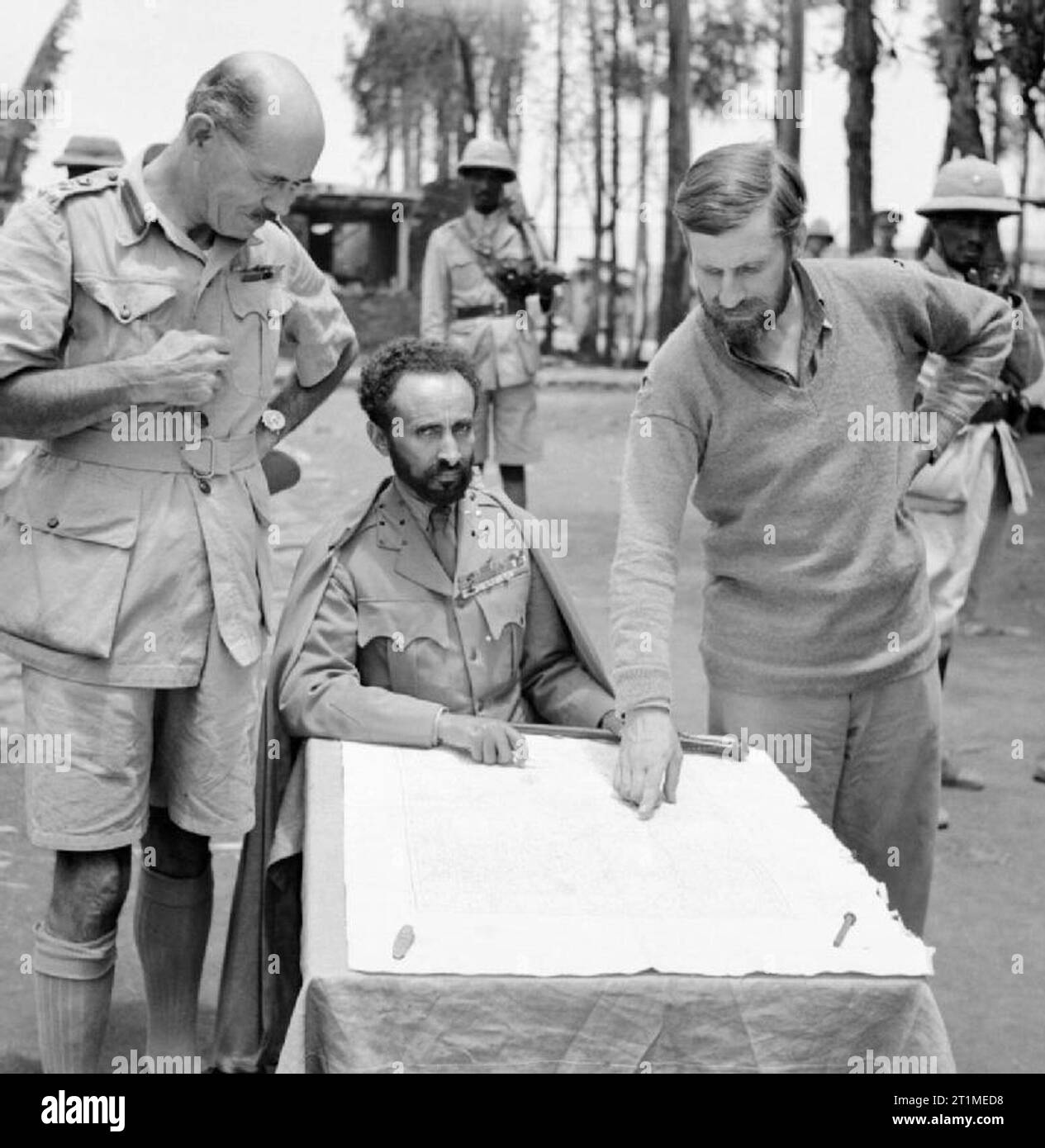 Haile Selassie, Emperor of Abyssinia, with Brigadier Daniel Arthur Sandford (left) and Colonel Wingate (right) in Dambacha Fort, after it had been captured, 15 April 1941. The Emperor of Abyssinia (modern day Ethiopia) with Brigadier Daniel Arthur Sandford on his left and Colonel Wingate on his right, in Dambacha Fort after it had been captured, 15 April 1941. Stock Photo
