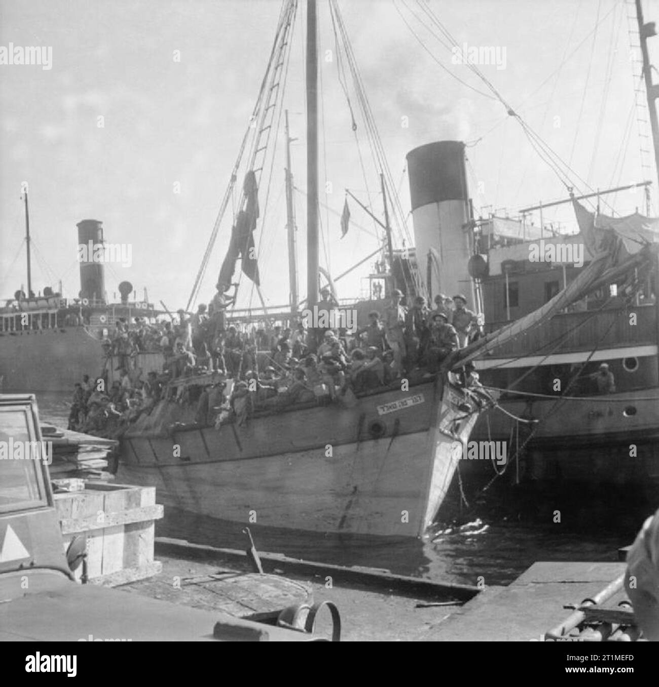 The British Mandate in Palestine 1917-1948 Illegal immigrants arriving into Palestine: British Army personnel on board the sailing vessel YAGOUR, loaded with illegal Jewish immigrants at Haifa docks. The illegal immigrants were taken to a camp in Cyprus while a decision was made about their future. Stock Photo