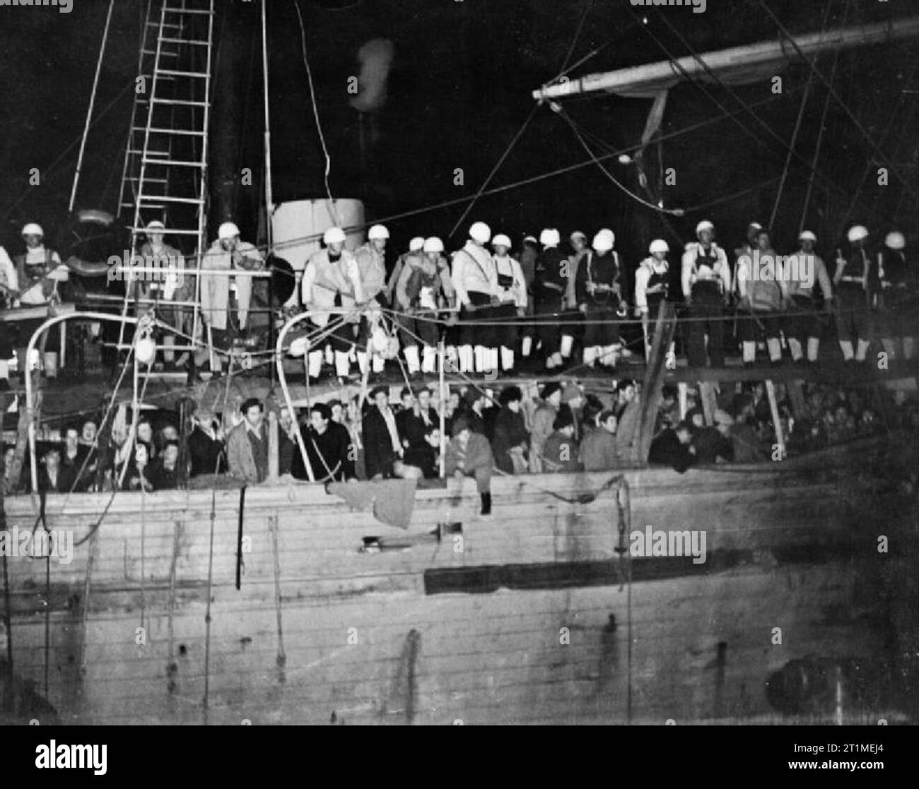 The British Mandate in Palestine 1917-1948 Illegal immigrants arriving into Palestine: The Jewish illegal immigrant ship LANEGEV at the port of Haifa. A Royal Navy boarding party are seen on board the over-crowded vessel. Stock Photo