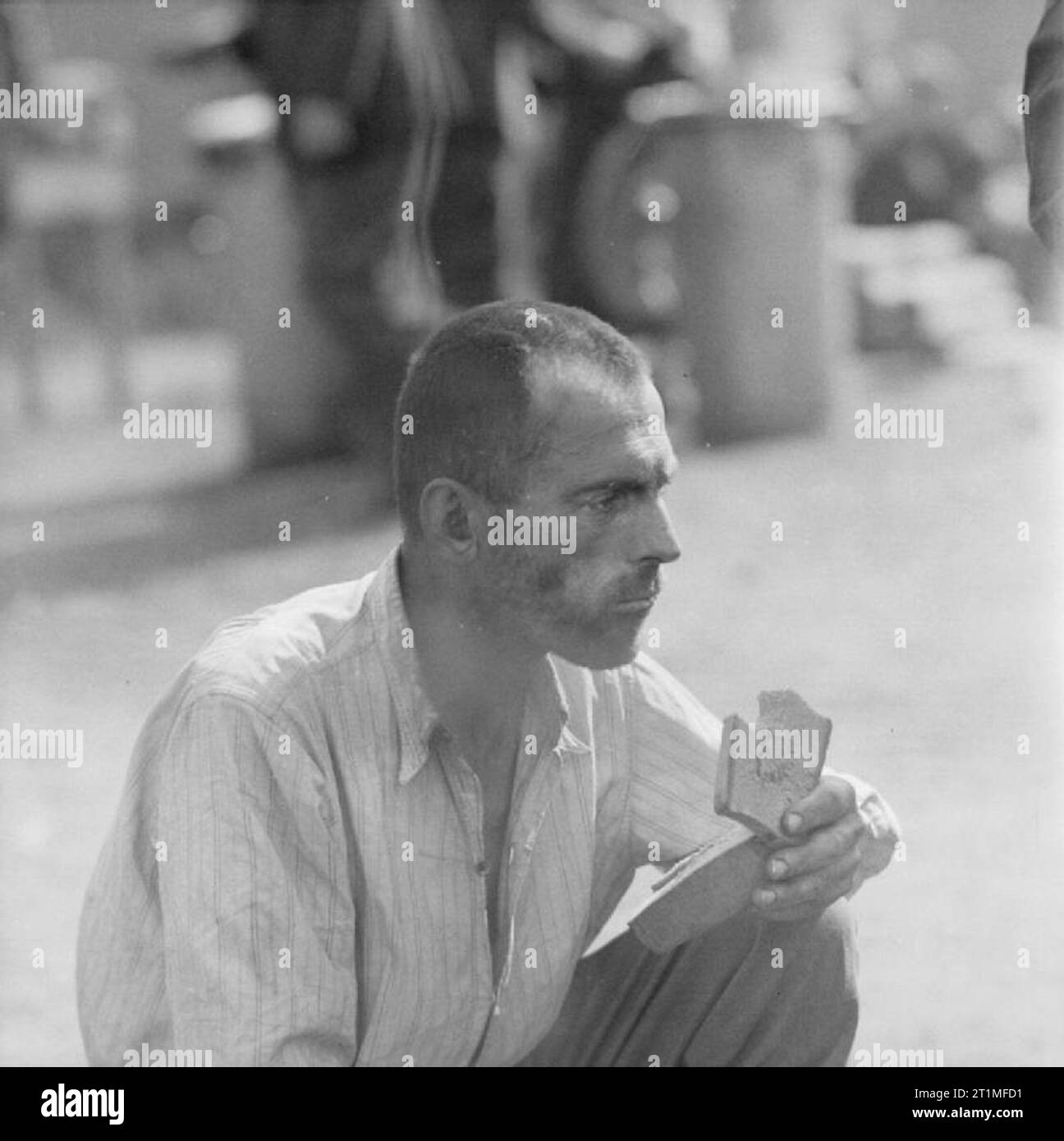 The Liberation of Bergen-belsen Concentration Camp, April 1945 Portrait of a camp inmate eating bread. Stock Photo