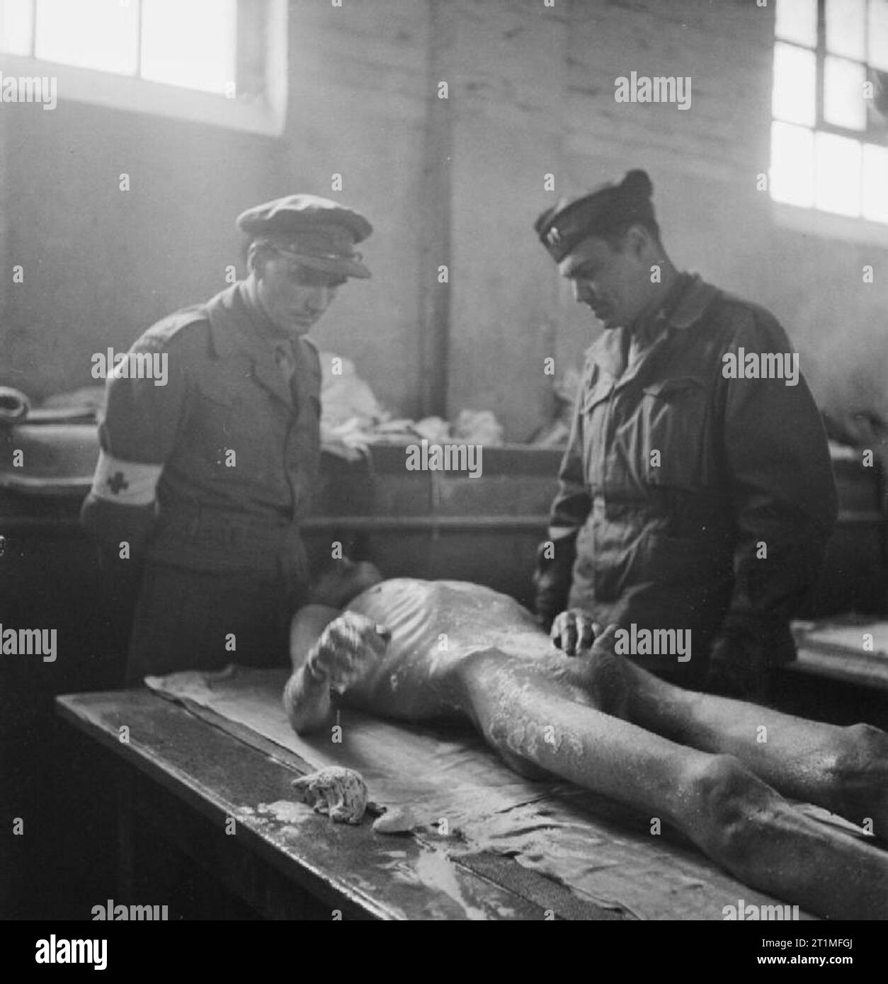 The Liberation of Bergen-belsen Concentration Camp, May 1945 Major E M Griffin RAMC of No 7 Mobile Bacteriological Laboratory (left) examines a patient in the 'Human Laundry', the cleansing station at the newly established hospital at Hohne Military Barracks, together with Captain W A Davies US Army, a consultant in typhus control attached to 21 Army Group by the US Army's Typhus Commission. Stock Photo