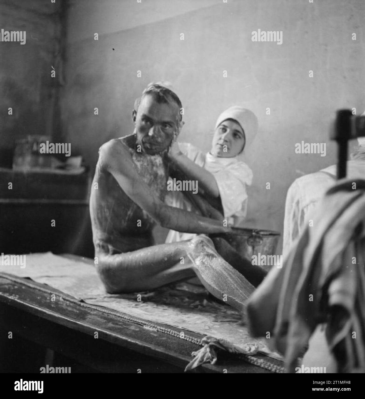 The Liberation of Bergen-belsen Concentration Camp, May 1945 A camp inmate is bathed by a German nurse. Stock Photo