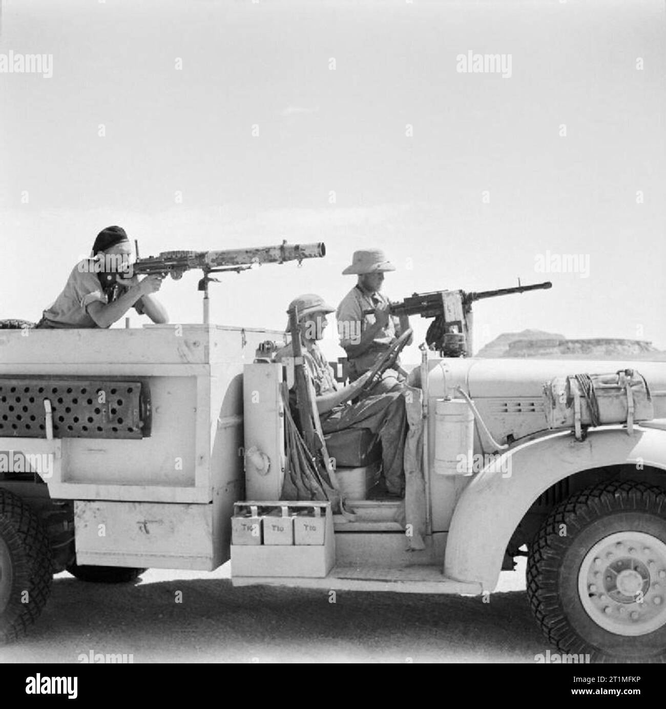 The Long Range Desert Group (lrdg) during the Second World War A posed close-up view of a Chevrolet truck and its three man crew in the Western Desert. The gunner beside the driver is manning an Italian Breda machine gun, while the soldier in the back is ready with the Lewis gun. Stock Photo