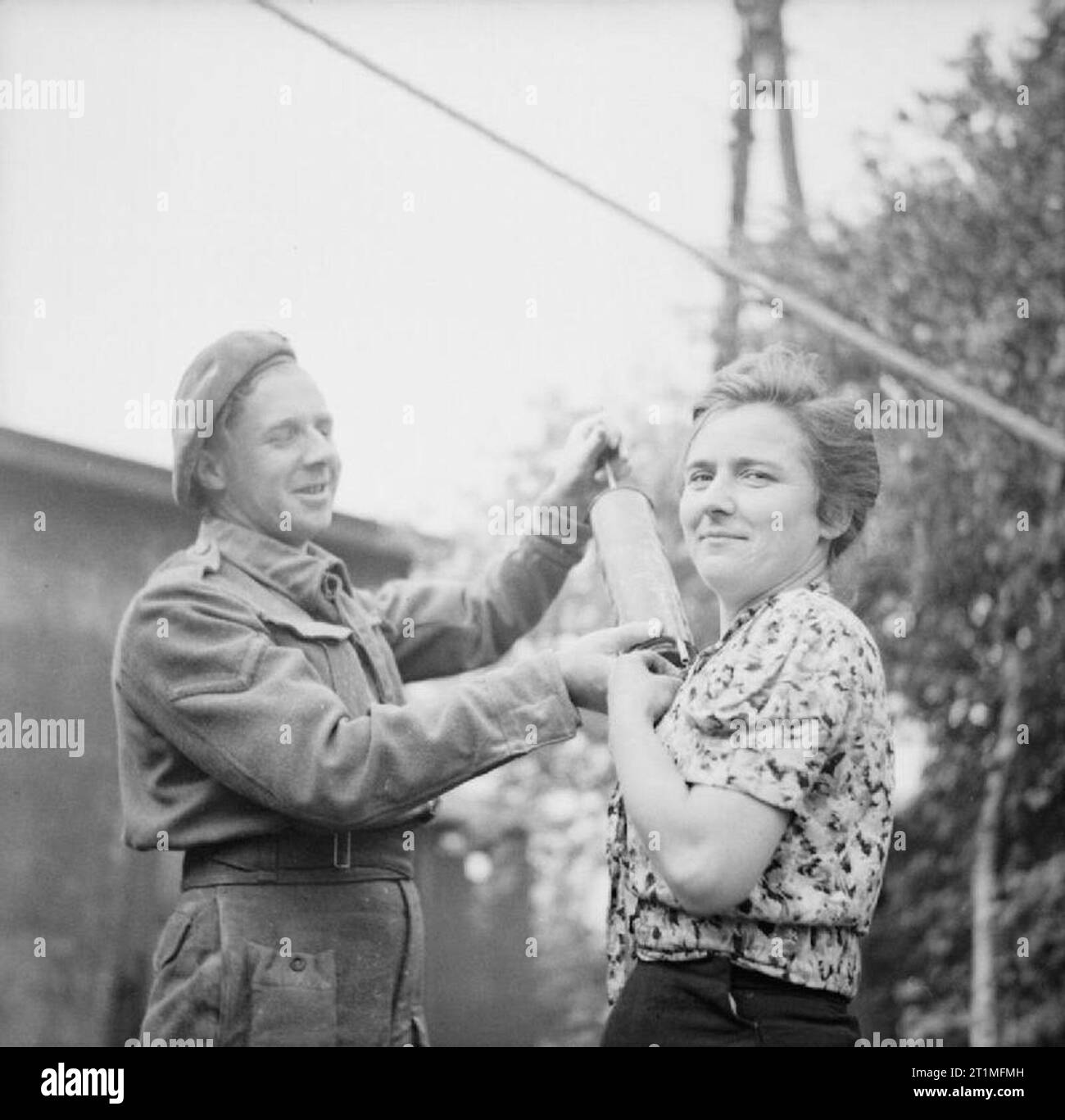 The Liberation of Sandbostel Concentration Camp, May 1945 Hygiene in the Field: A Royal Army Medical Corps orderly dusting a former female inmate of the Sandbostel Concentration Camp with DDT powder. Prevention of diseases, such as typhus, among the huge numbers of displaced persons in the North West Europe became an important priority for the RAMC. Stock Photo