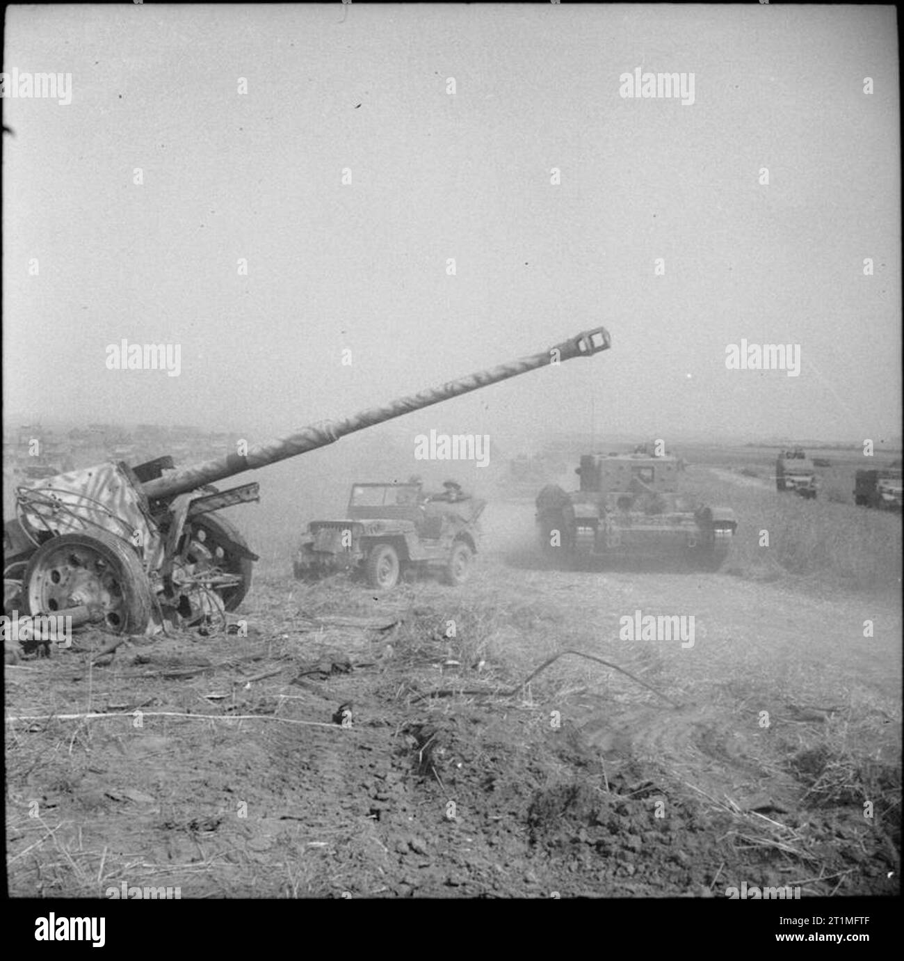 The Polish Army in the Normandy Campaign, 1944 A Cromwell tank of the 1st Polish Armoured Division and jeep pass an abandoned German 88mm anti-tank gun during Operation 'Totalise'. Stock Photo