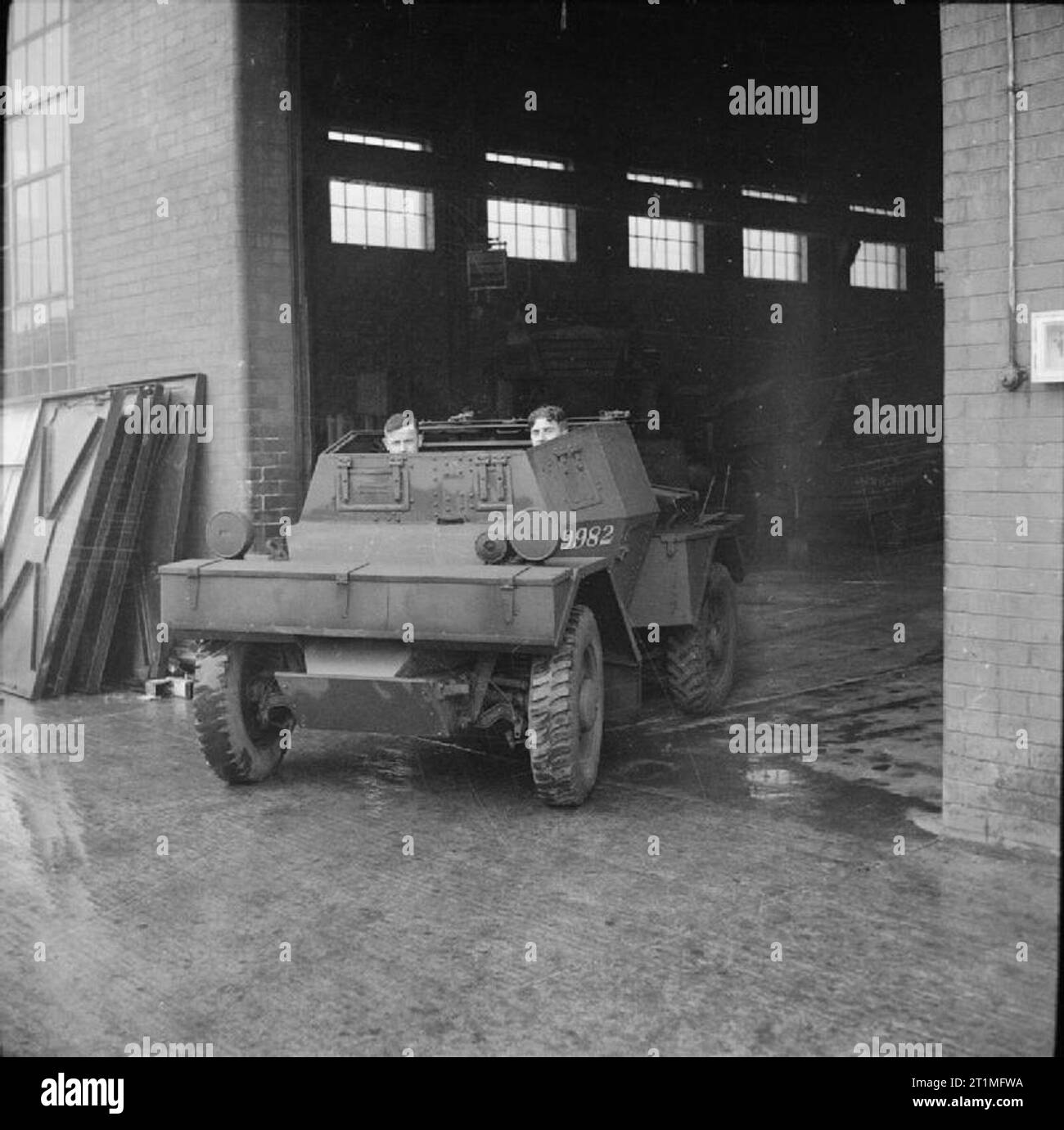 The Royal Electrical and Mechanical Engineers in Britain, 1942 A reconditioned Scout Car (Car, Scout, Daimler, Mk 1 ['Dingo']), vehicle number F9982, leaving the Royal Electrical and Mechanical Engineers' (REME) depot for a road test after a complete overhaul. Stock Photo