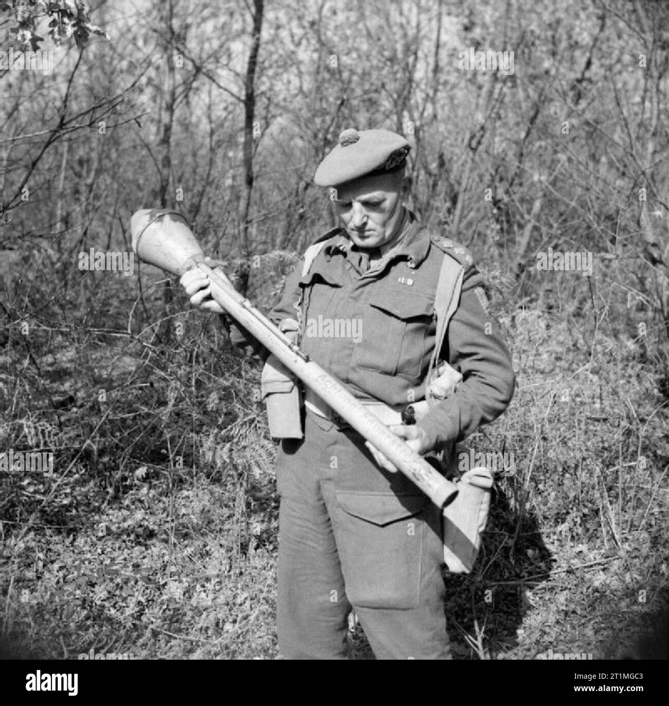 Captain W Guest-Gordons, Intelligence Officer with No. 2 Infantry Brigade, examines a German Panzerfaust anti-tank weapon, Anzio, 27 February 1944. Captain W Guest-Gordons, Intelligence Officer with No. 2 Infantry Brigade, examines a German Panzerfaust anti-tank weapon, Anzio, 27 February 1944. Stock Photo