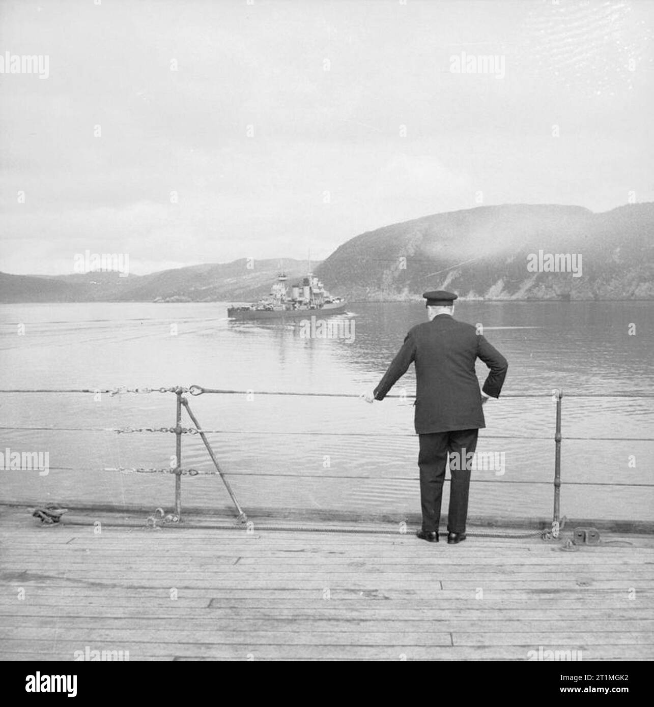 Winston Churchill during the Second World War Prime Minister Winston Churchill looks out from the deck of HMS Prince of Wales as USS Augusta sails away following the Atlantic Conference onboard the vessel with US President Franklin D Roosevelt in August 1941. Stock Photo