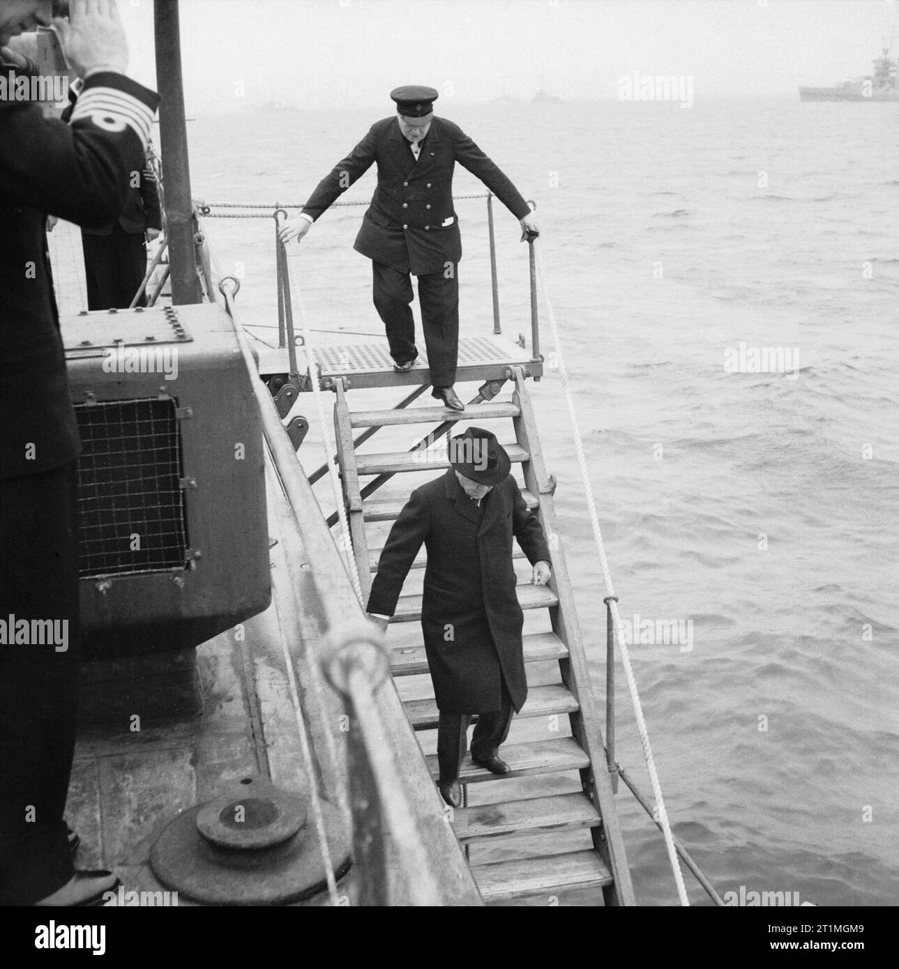 Winston Churchill during the Second World War Lord Maxwell Beaverbrook and the Prime Minister Winston Churchill leave HMS PRINCE OF WALES to board USS AUGUSTA from a launch boat for the Atlantic Conference with US President Franklin D Roosevelt in August 1941. Stock Photo