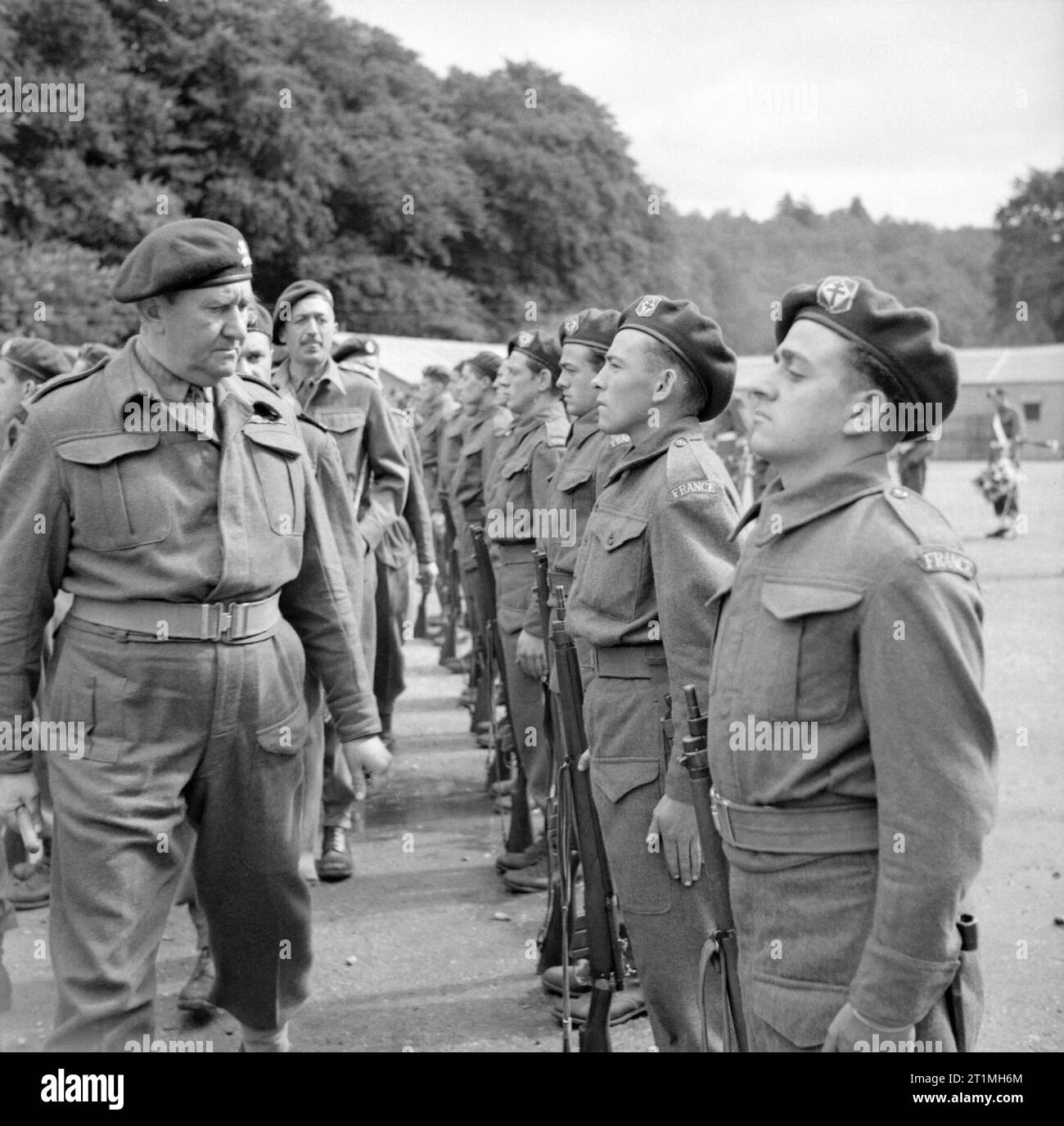 Lieutenant Colonel Charles Vaughan, Commandant Commando Depot, inspecting French troops during a parade to mark Bastille Day at Achnacarry in Scotland, 17 July 1943. French commando troops undergoing training at Achnacarry House in Scotland: Lieutenant Colonel Charles Vaughan, Commandant, Commando Depot, inspecting French troops during a parade and march past as part of Bastille Day celebrations. Stock Photo