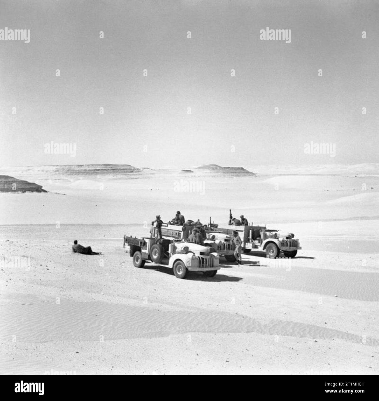 LRDG (Long Range Desert Group) Chevrolet 30-cwt trucks, 25 May 1942. Three Long Range Desert Group 30-cwt Chevrolet trucks, surrounded by desert. Stock Photo