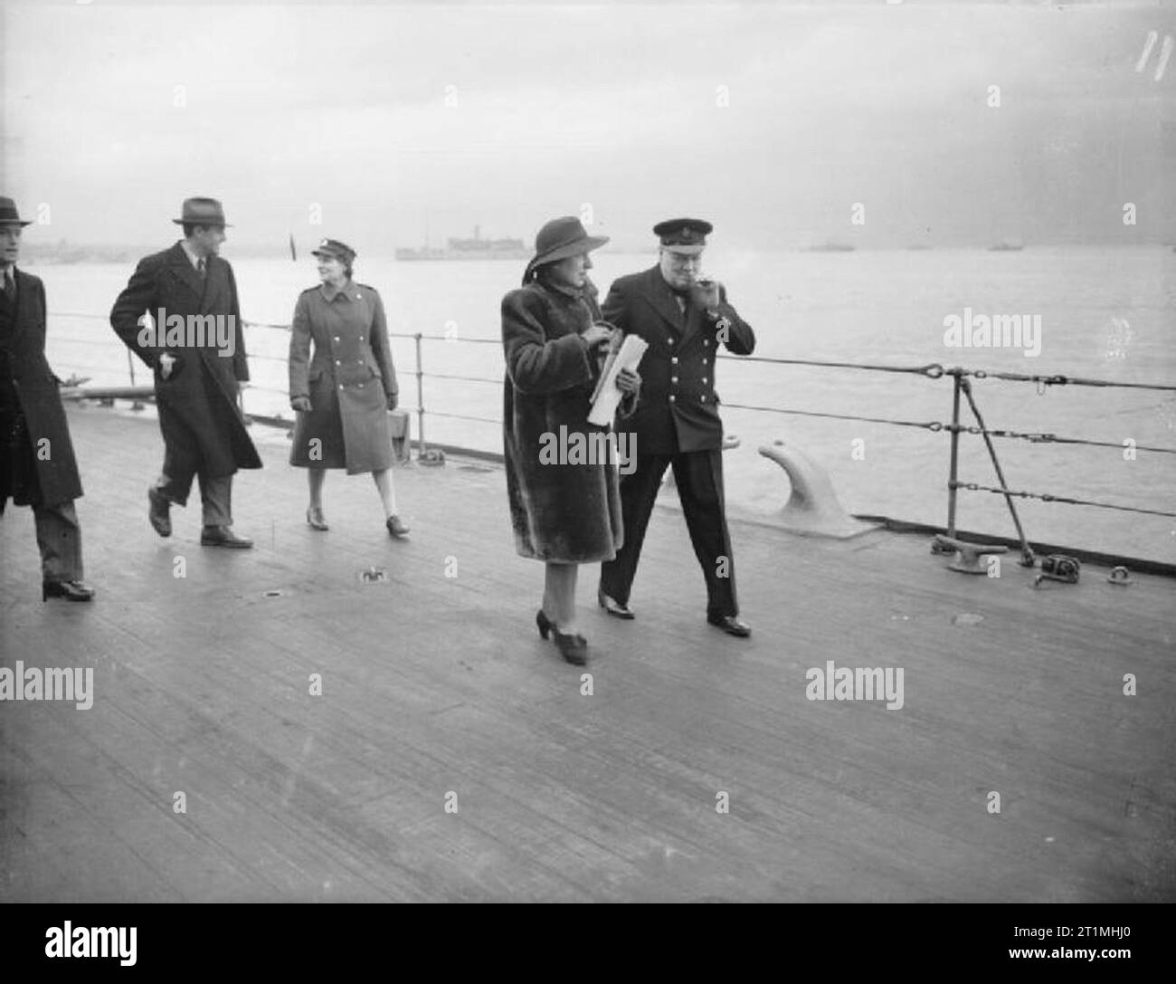 Prime Minister Winston Churchill Aboard HMS Duke of York For Visit To America, December 1941 Prime Minister Winston Churchill walks along the deck of HMS DUKE OF YORK with his secretary Mrs Hill. In the background is Mary Churchill, the PM's daughter and Mr Harriman, the US Ambassador and special representative to the Prime Minister. Stock Photo