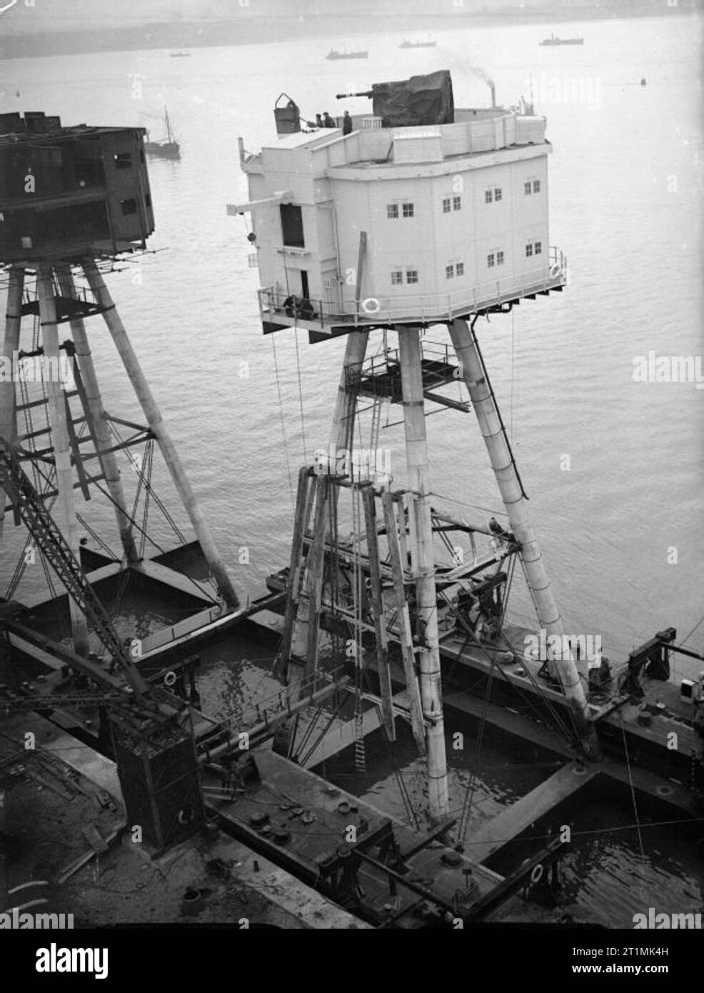 The Royal Navy during the Second World War 120 foot Maunsell anti-aircraft forts for use in the Mersey Estuary under construction at Bromborough Dock. Here they are well on the way to completion with the accommodation block fitted to the four long legs that will rest on the sea bed. Stock Photo