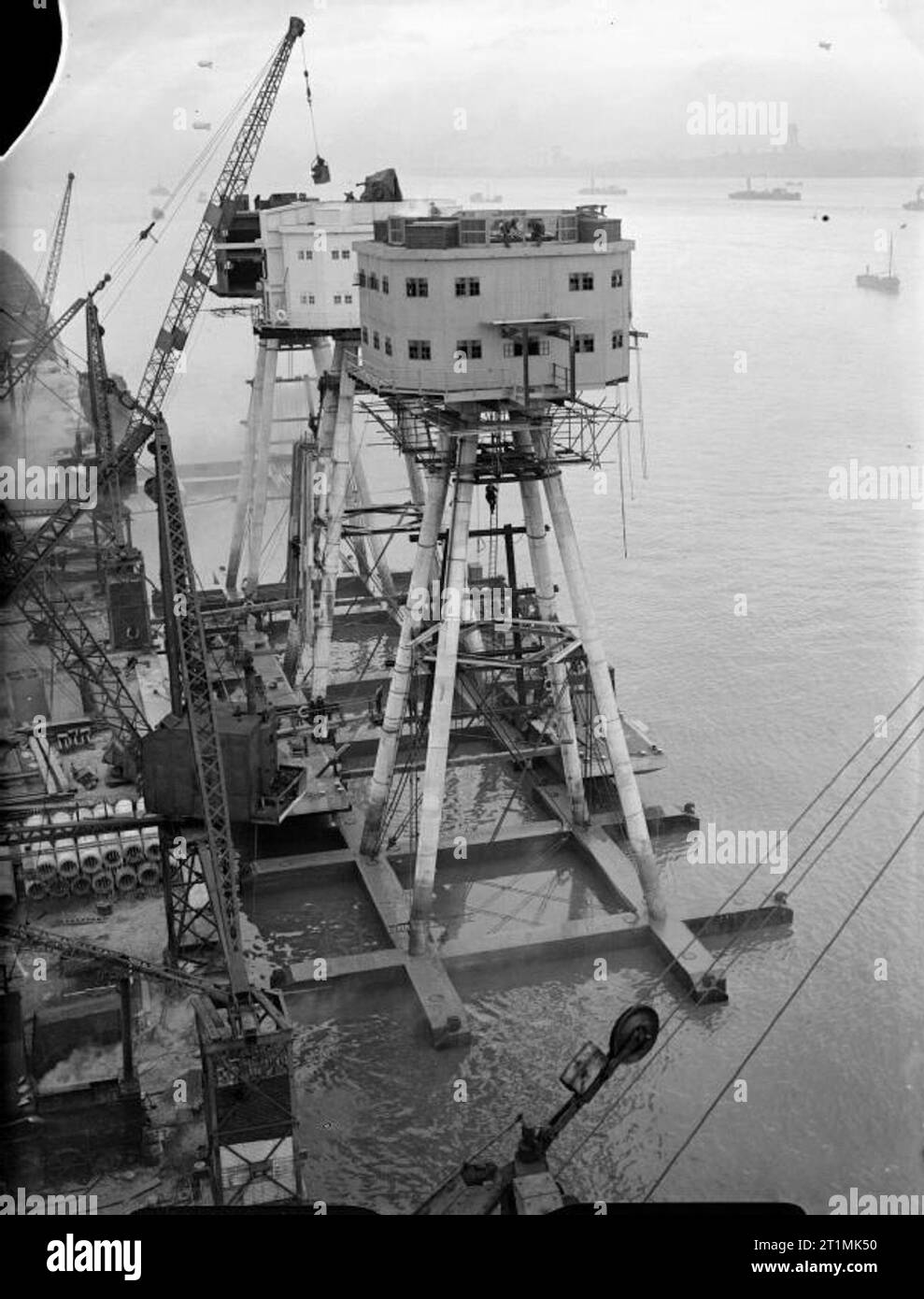 The Royal Navy during the Second World War 120 foot Maunsell anti-aircraft forts for use in the Mersey Estuary under construction at Bromborough Dock. Here they are well on the way to completion with the accommodation block fitted to the four long legs that will rest on the sea bed. Stock Photo