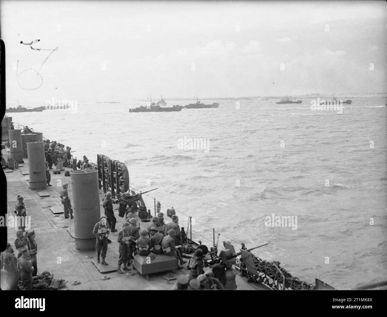 D-day - Allied Forces during the Invasion of Normandy 6 June 1944 British troops and US sailors manning 20mm gun positions on board USS LST-25 watch LCI(L) landing craft head towards the beaches of Gold assault area, 6 June 1944. Stock Photo