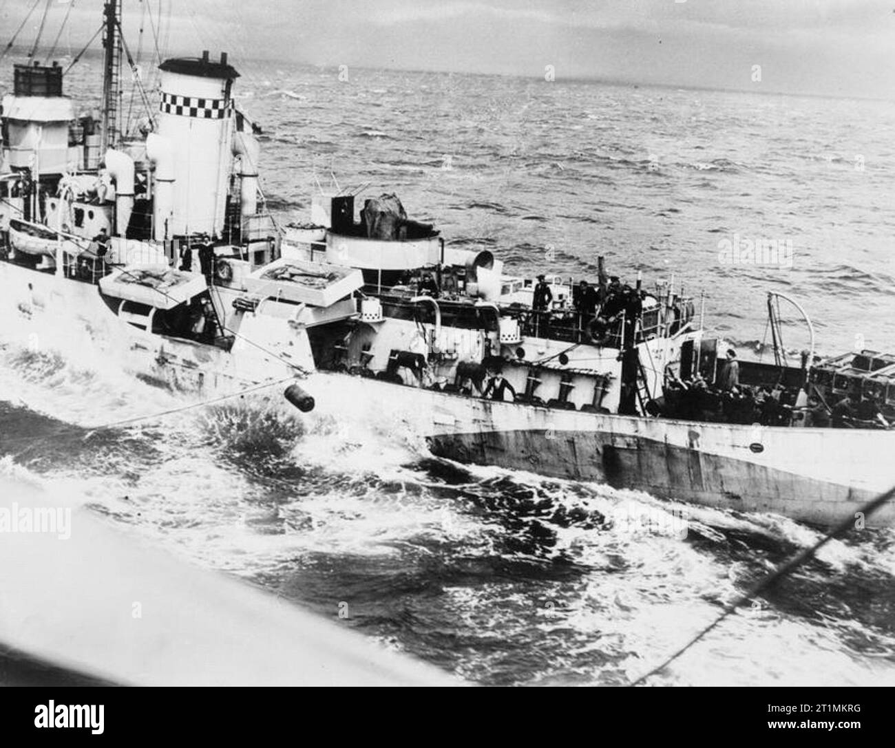 Depth Charge Transfer at Sea. 15 July 1943, on Board the Oiler Ss Luminetta, Off Greenock. The depth charges being transferred to the RENONCULE, Free French Corvette. This method has proved very successful with ships in convoy. Stock Photo