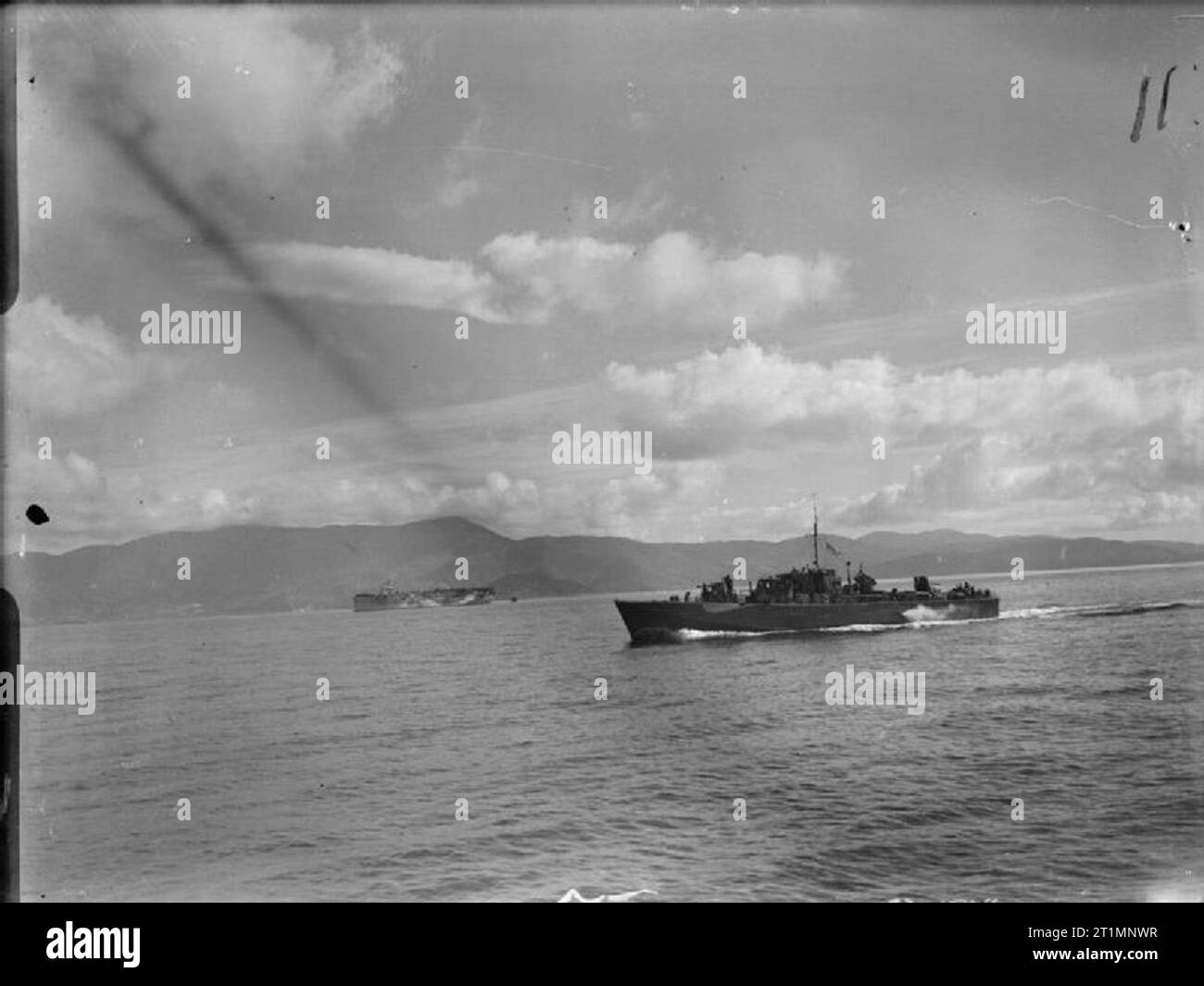 The Royal Navy during the Second World War MGB 646 on its way to Skiathos, Greece, with the escort carrier HMS STALKER in the background. After its liberation Skiathos was used as an advanced base for the assault on Salonika. Stock Photo