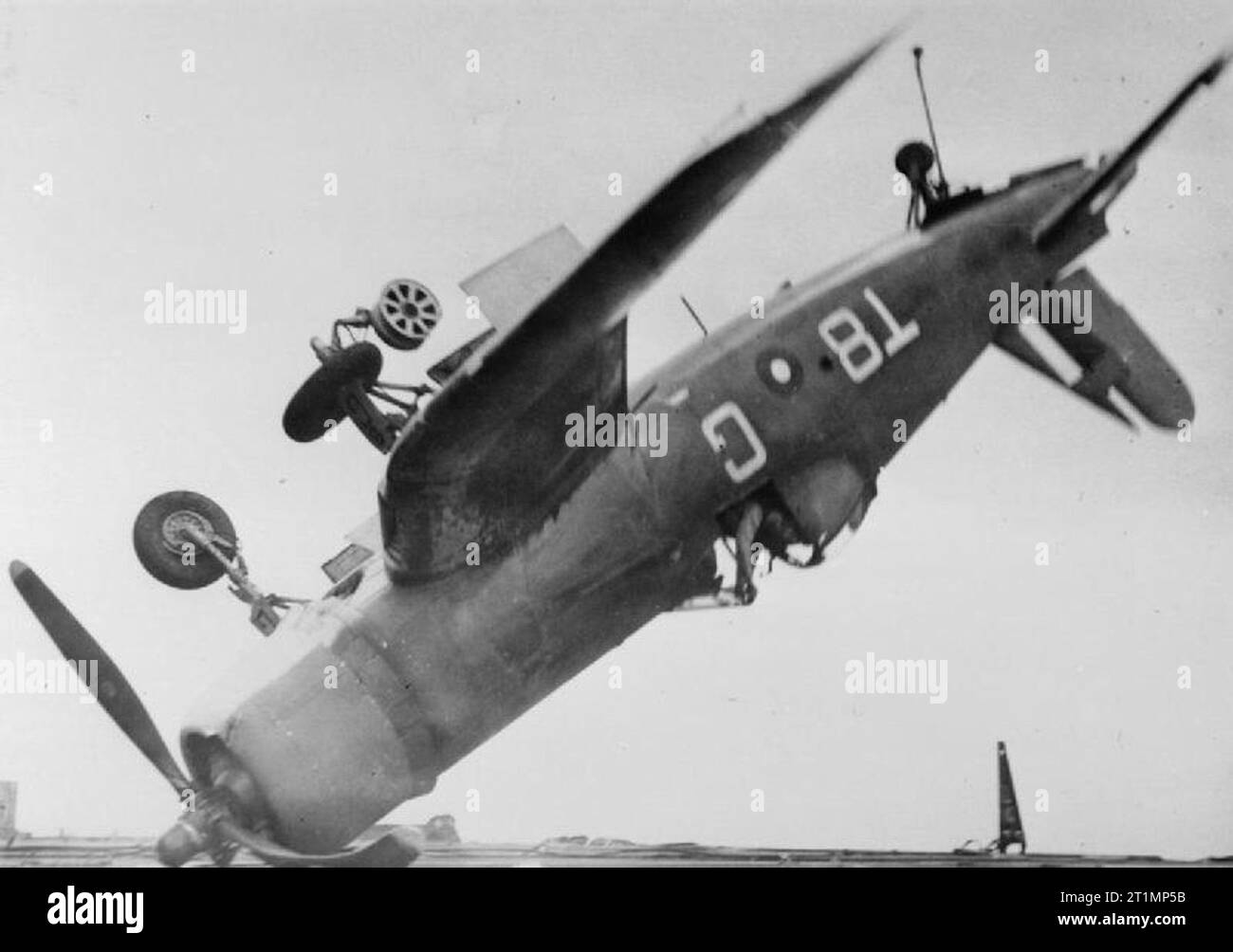 Original description: 'The pilot of this Chance-Vought Corsair fighter which crashed through the barrier of HMS Smiter when landing on and ended upside down resting at around forty five degrees, escaped with only a bruised thumb. This took place during operations against Sakishima in support of the American landing on Okinawa.' Stock Photo