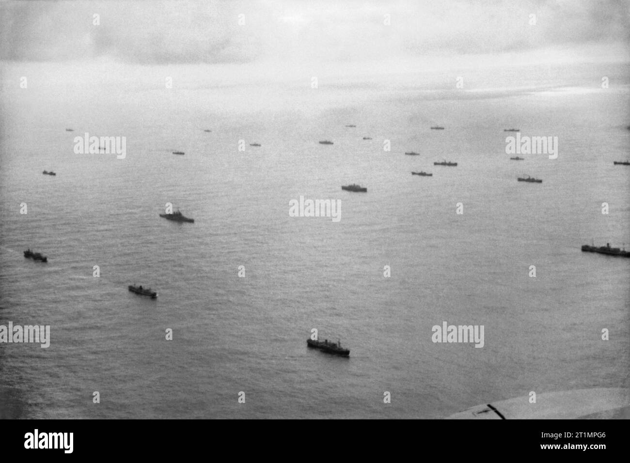 The Royal Navy during the Second World War An aerial view of a convoy escorted by a battleship during the Battle of the Atlantic. The ships stretch as far as the eye can see. Stock Photo