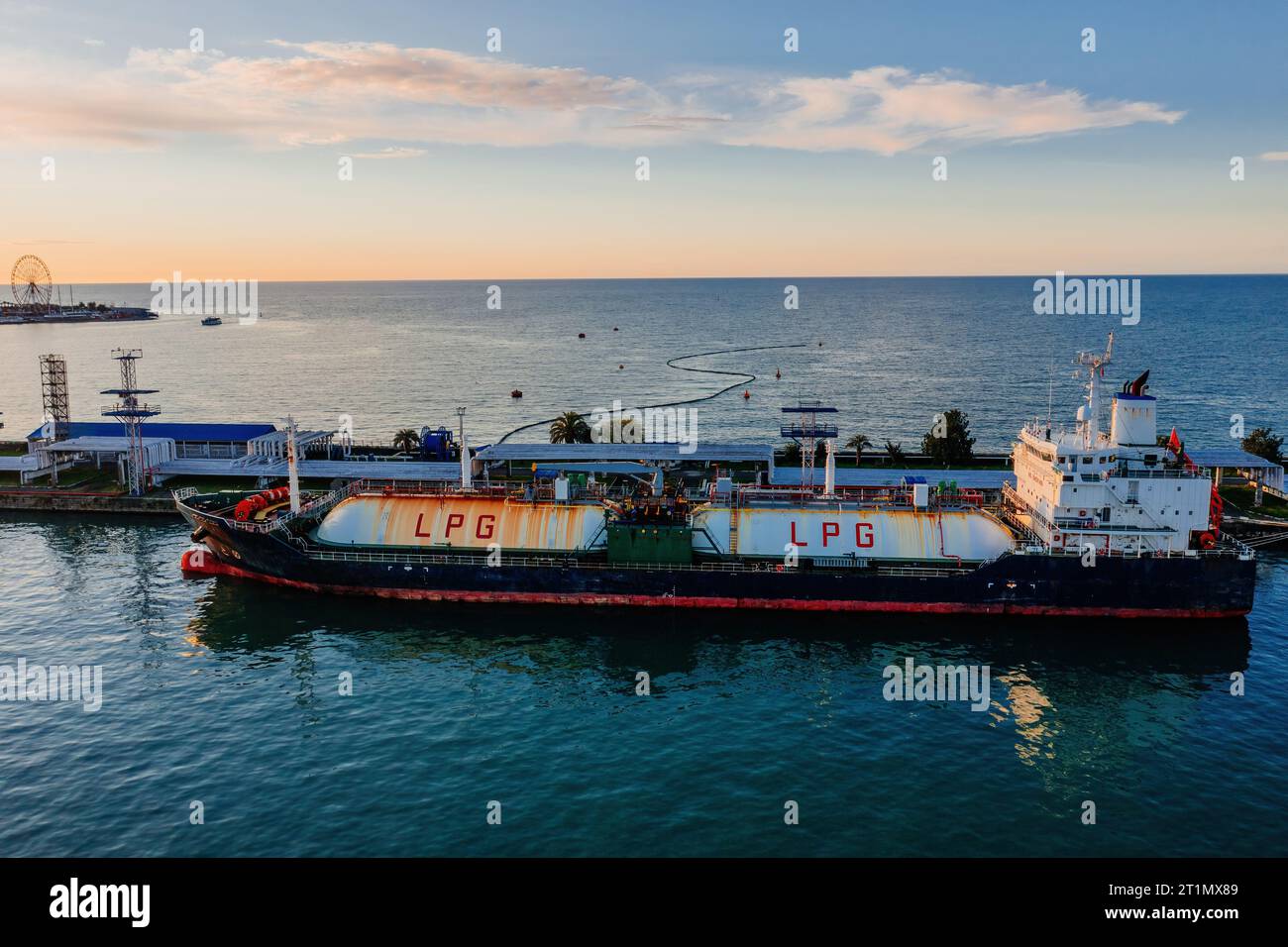 Ship tanker with LPG. Process of loading of tanker in the port, drone aerial view. Stock Photo