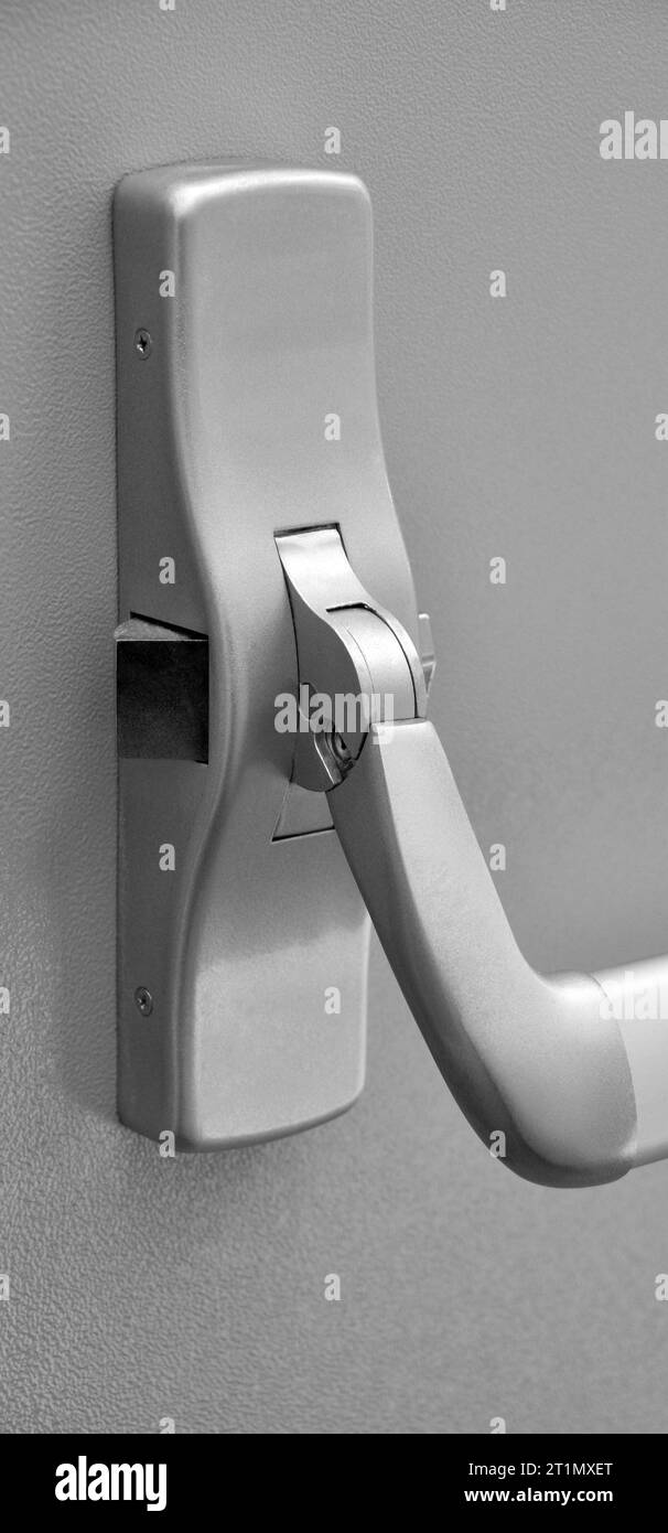 Emergency exit door. Closed up latch door handle of emergency exit. Push bar and rail for panic exit Stock Photo