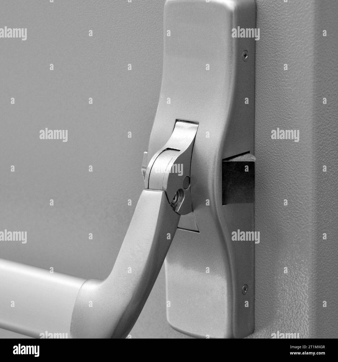 Emergency exit door. Closed up latch door handle of emergency exit. Push bar and rail for panic exit Stock Photo