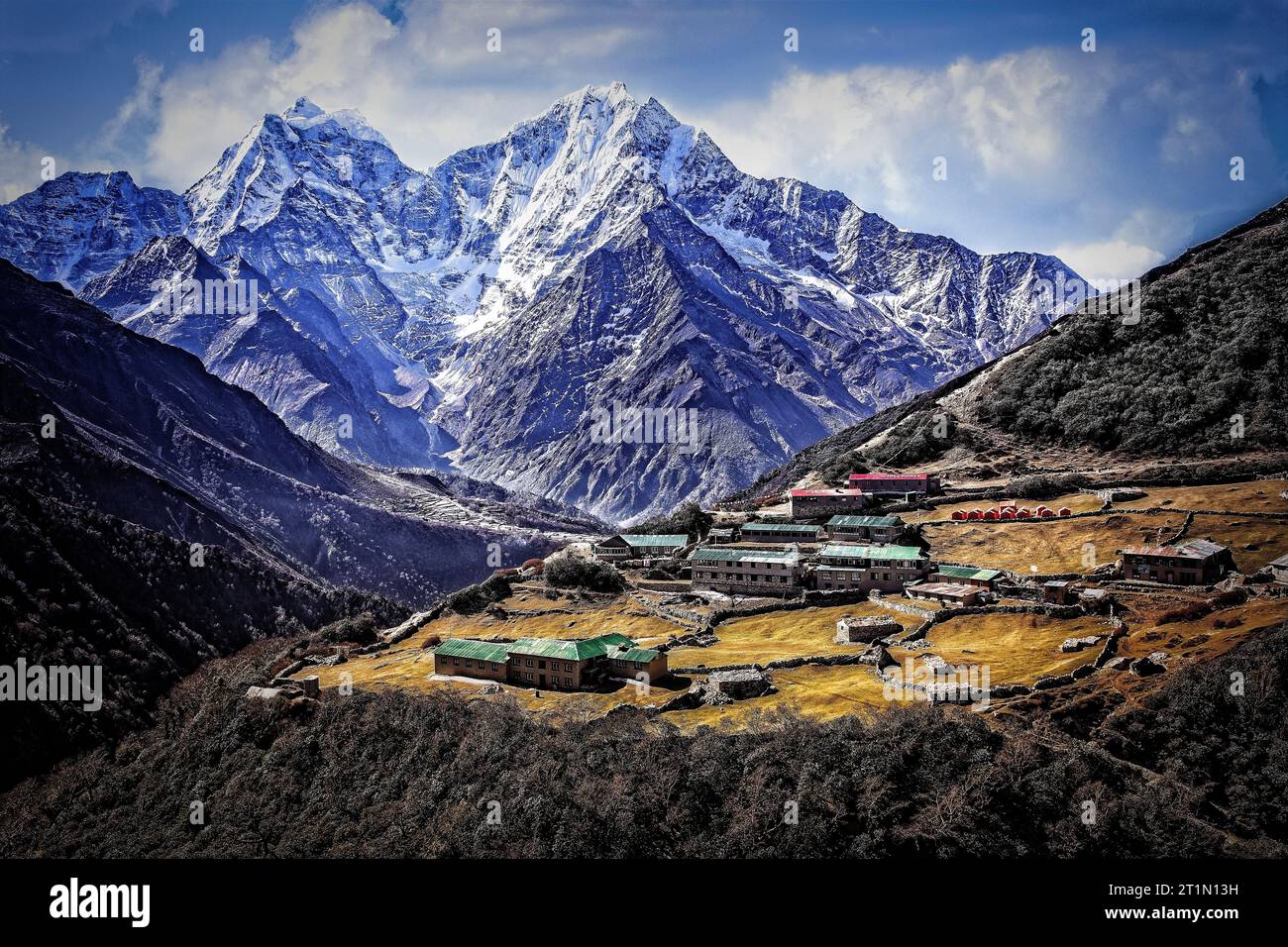 The village of Dhole backed by Himalayan snow capped Kangtega  and Thamserku in the Khumbu region of Sagarmatha National Park, Nepal. Stock Photo