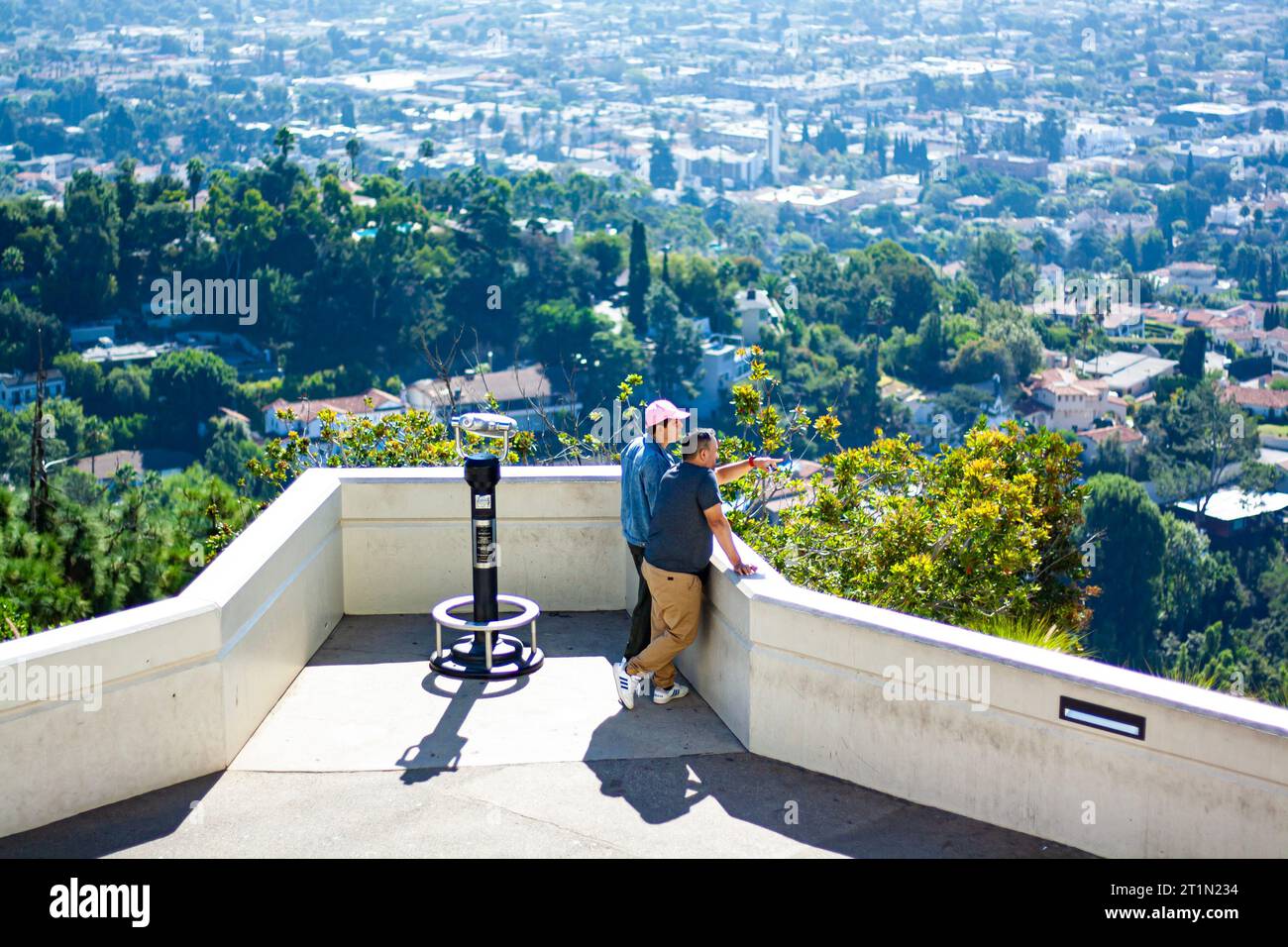 Two men pointing at the Los Angeles skyline from Griffith Observatory Stock Photo