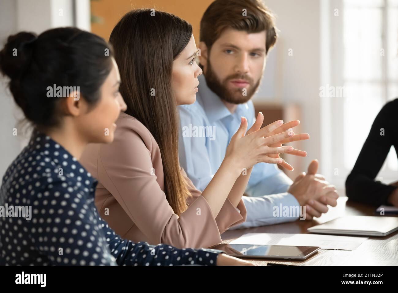 Diverse millennial startup team discussing work project Stock Photo