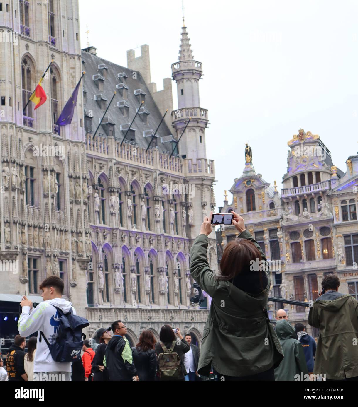 Grand Place, Brussels, Belgium. Tourists at Grand Place Brussels in gloomy day. Stock Photo