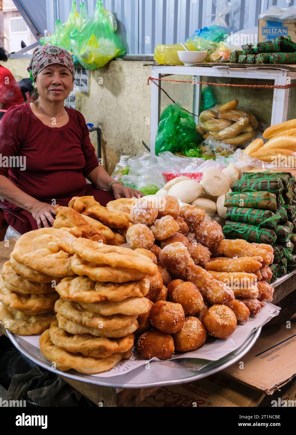 Cat Ba, Vietnam. Vendor Selling Bread and Pastries, Early Morning. Stock Photo