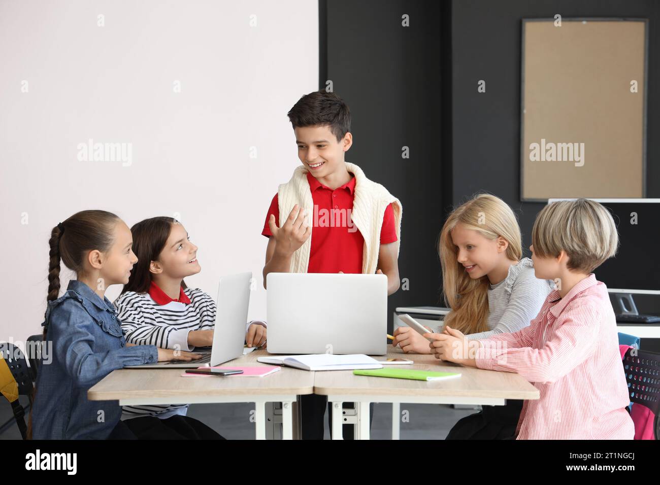 Little children studying with devices at school computer lab Stock ...