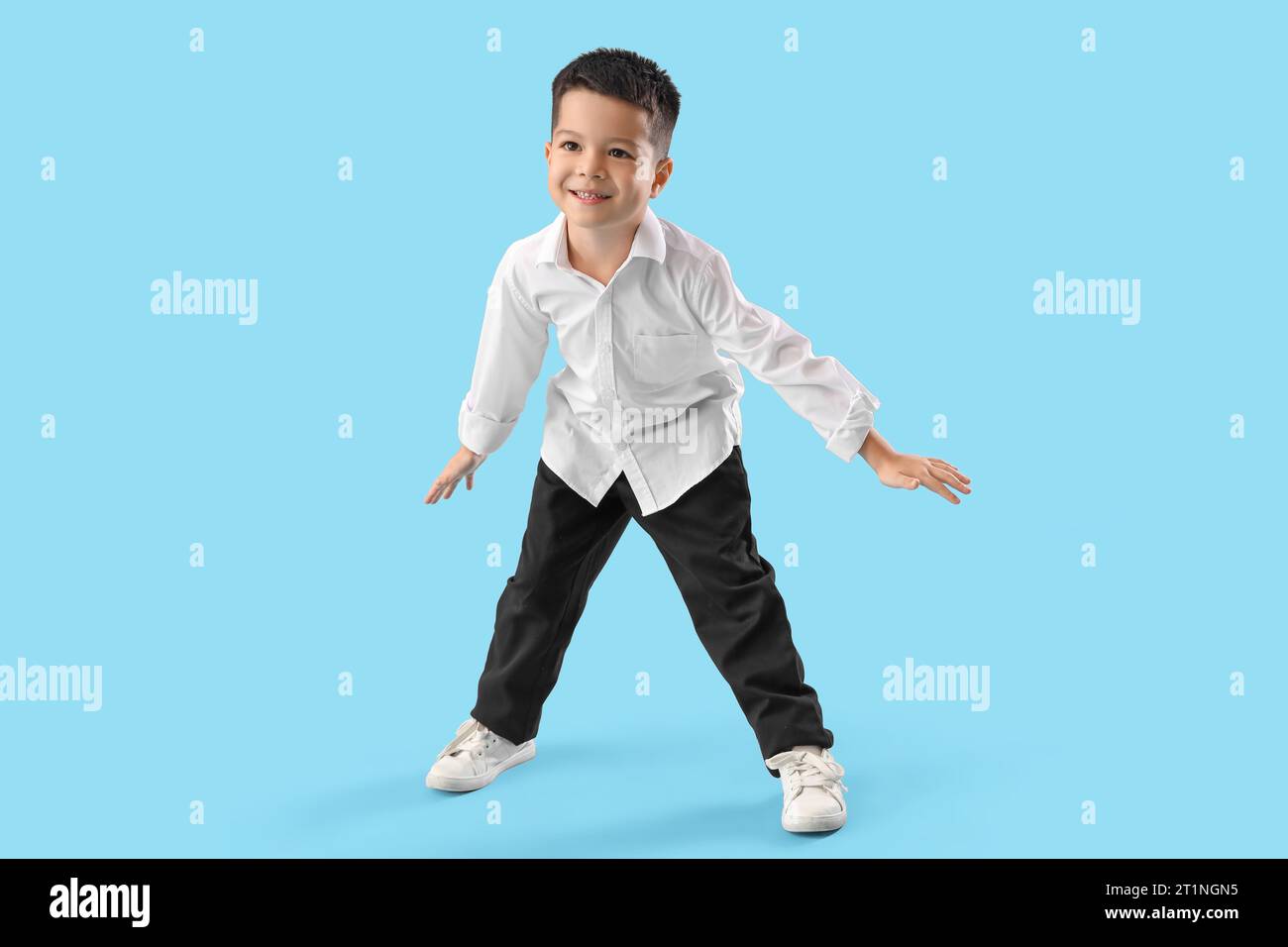 Little Asian boy dancing on blue background Stock Photo - Alamy