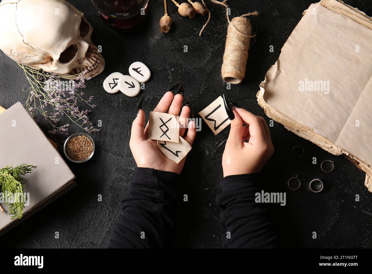 Witch with runes and magic attributes on dark background Stock Photo ...