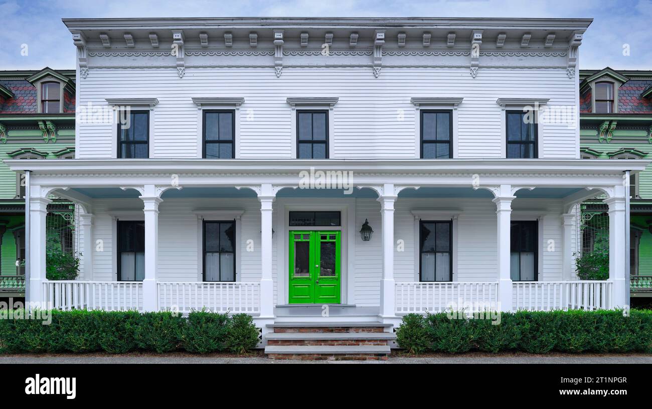 Old fashioned white clapboard house with wide porch Stock Photo