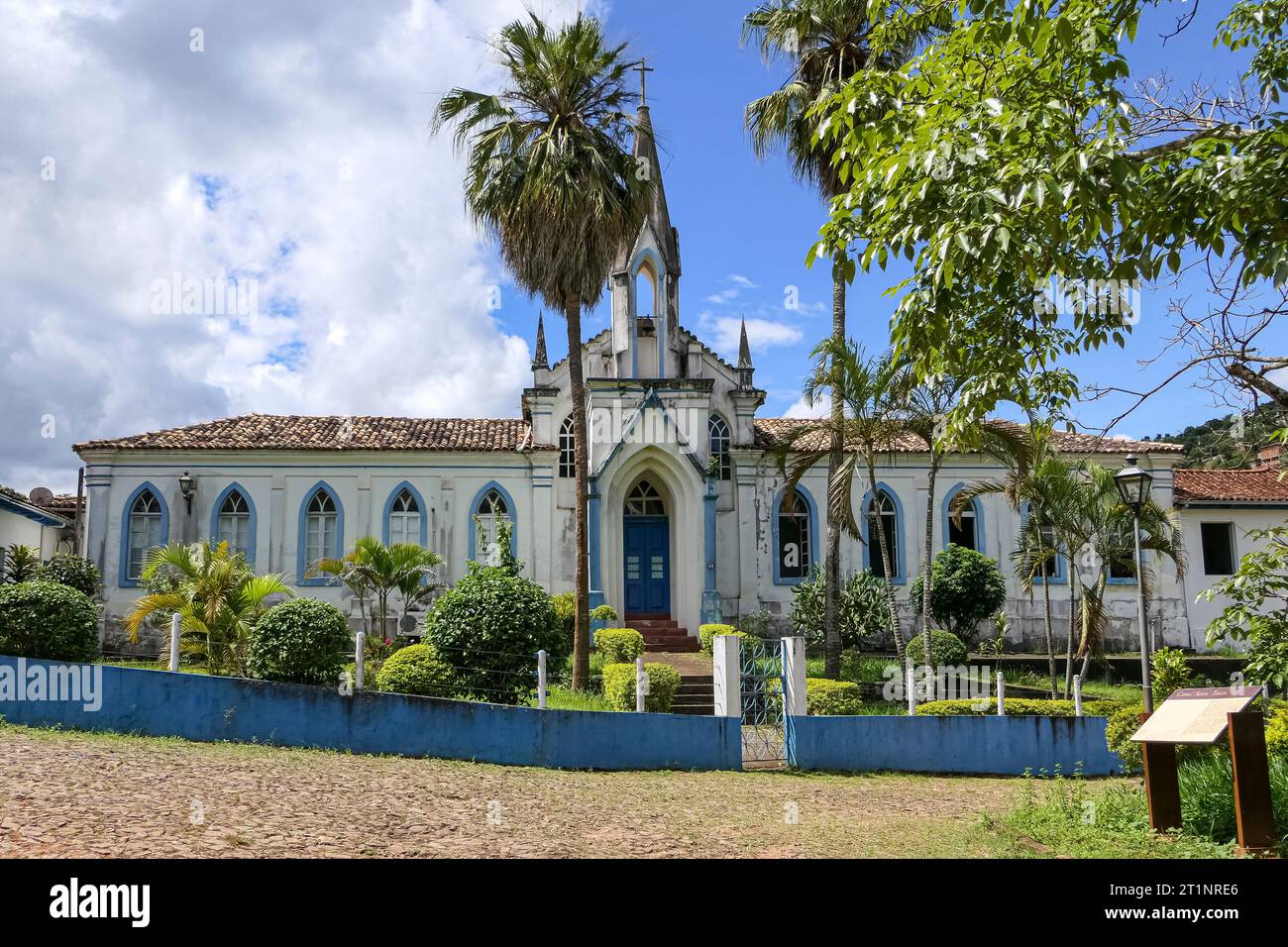 Colonial church in the historical town of Serro with palm trees in sunshine, Minas Gerais Brazil Stock Photo