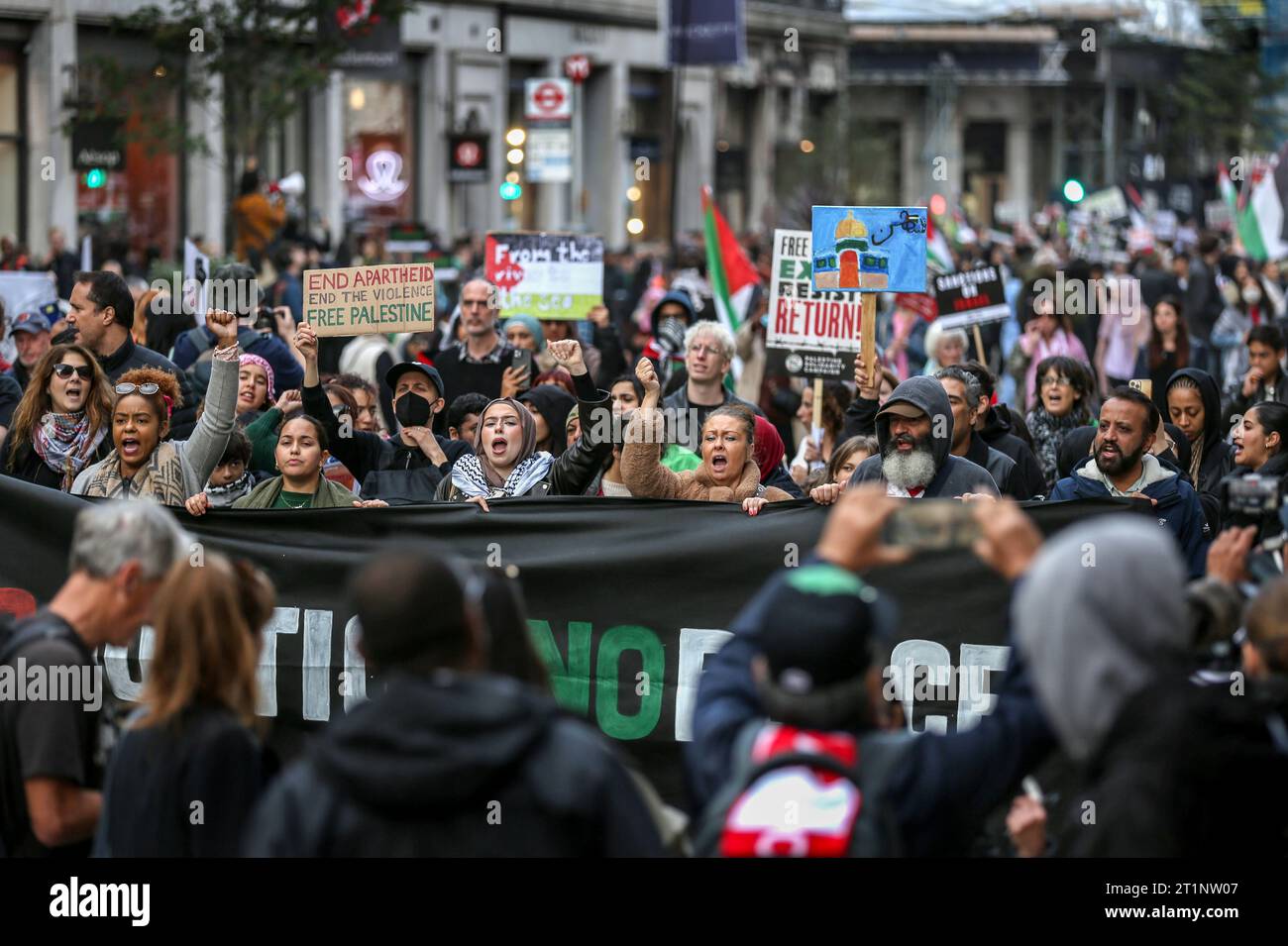 London, UK. 14th Oct, 2023. Protesters march along Haymarket behind a ...