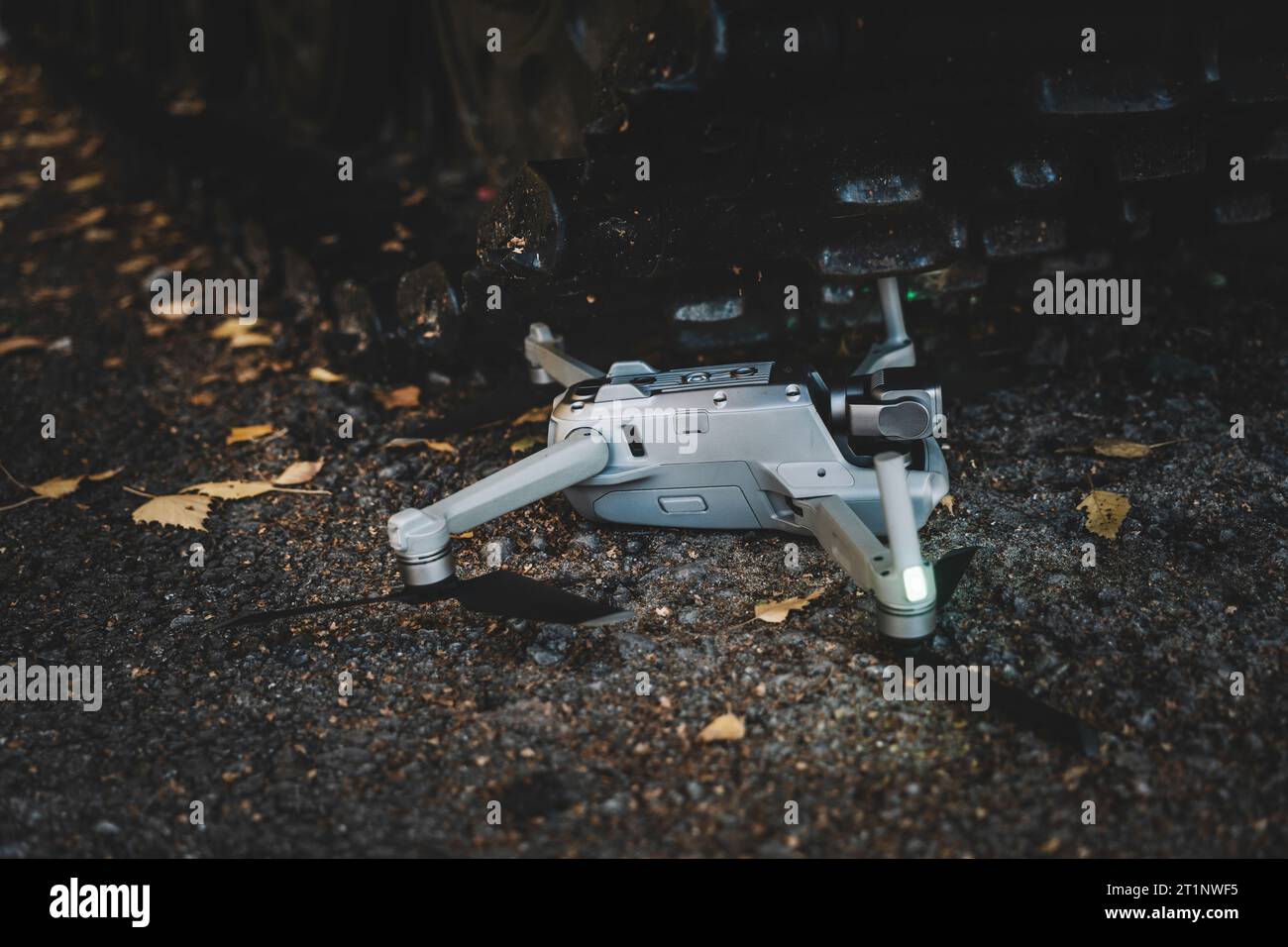 downed drone under tank tracks. The concept of modern military conflicts.. help of reconnaissance drones in modern warfare. the crash of a drone in th Stock Photo